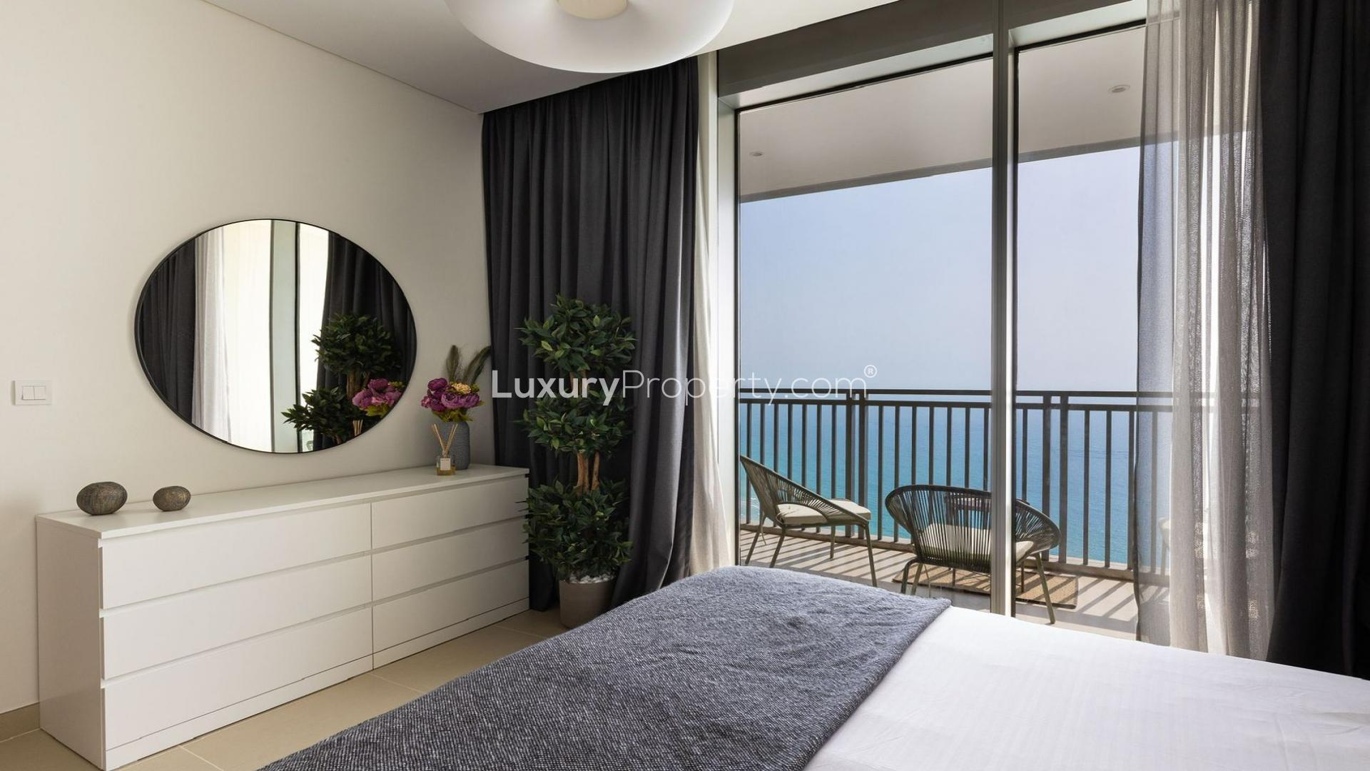 Modern bedroom in Dubai Marina apartment with balcony and stunning marina views