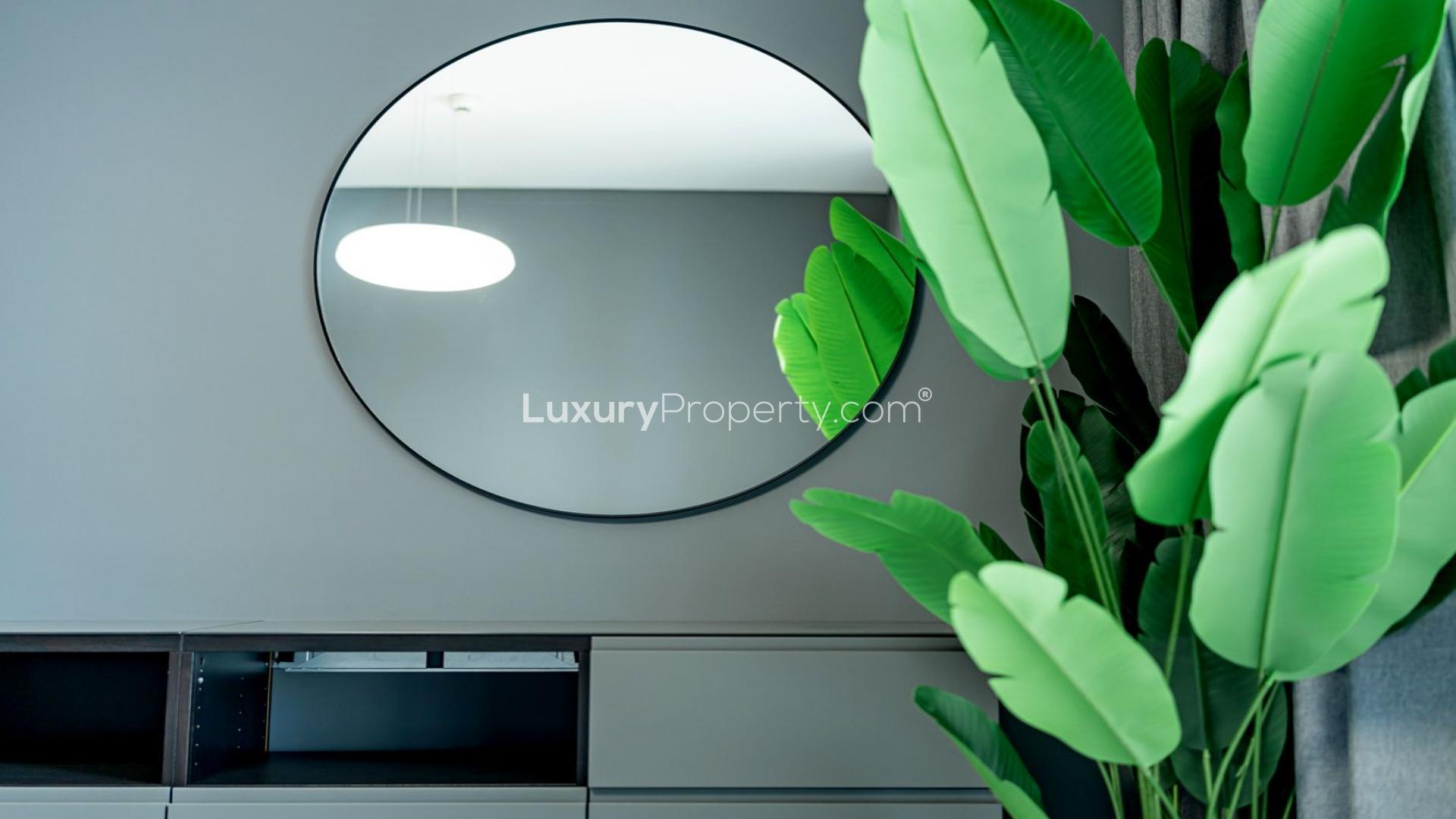 Modern Dubai Marina apartment interior with decorative flowers and abstract art on the wall