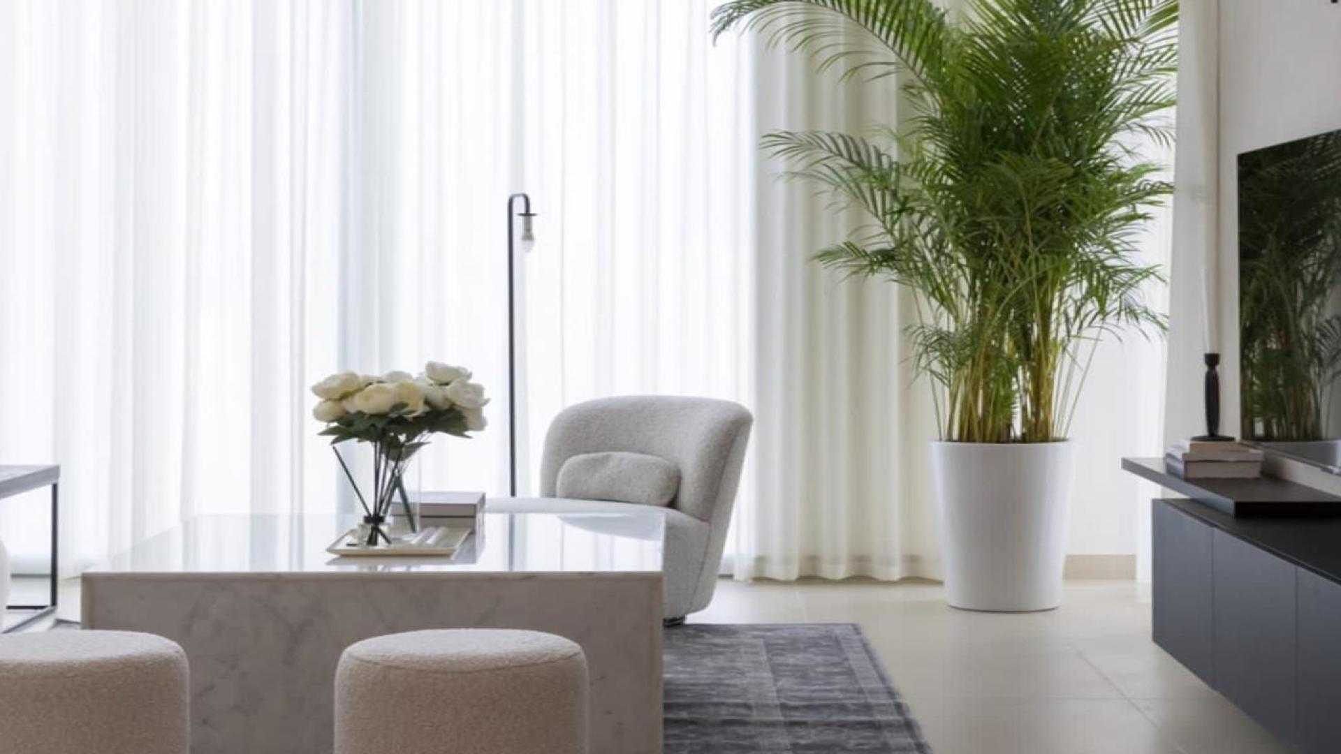 Modern open-plan living room and kitchen in Marsa Dubai apartment for rent