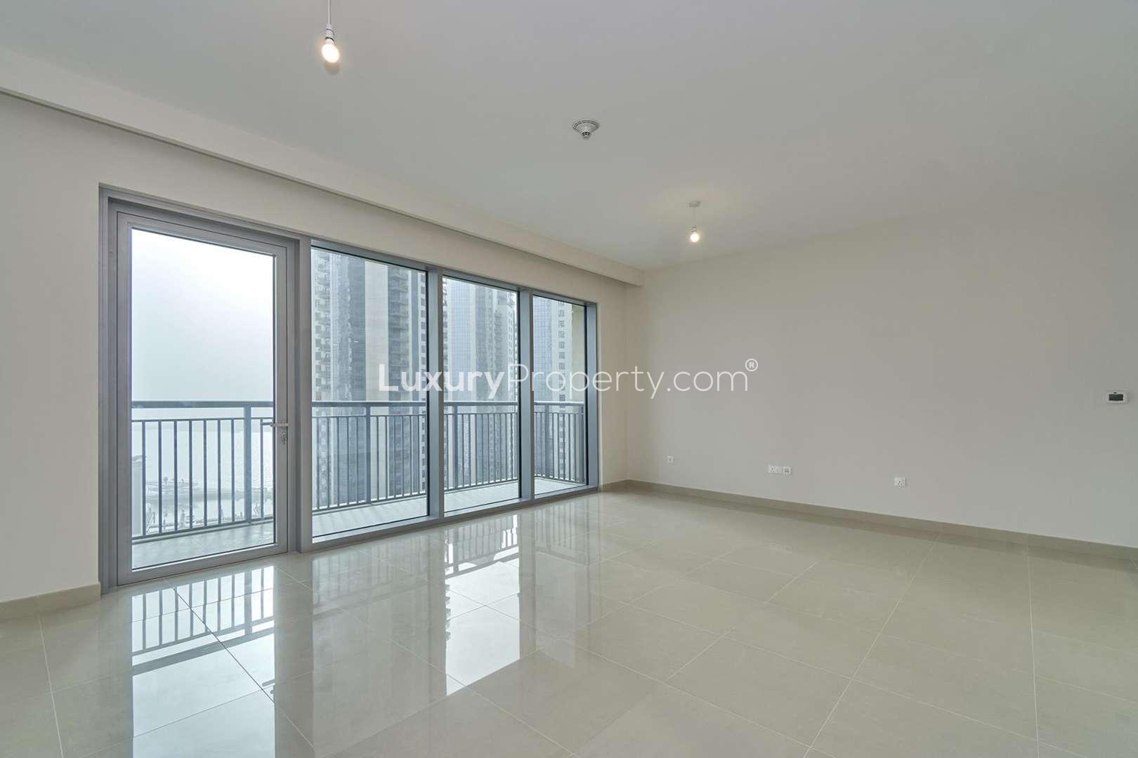 Spacious living area in Dubai Creek Harbour apartment with modern kitchen, Burj Khalifa views