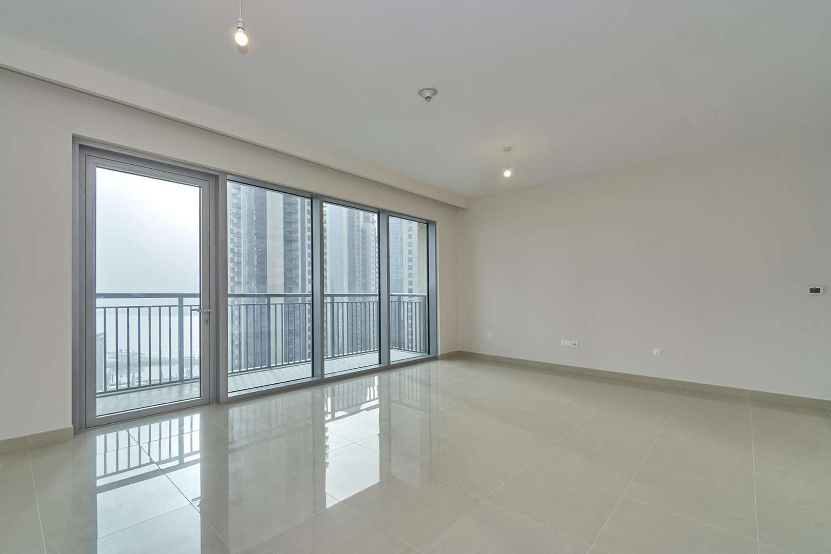 Spacious living area in Dubai Creek Harbour apartment with modern kitchen, Burj Khalifa views