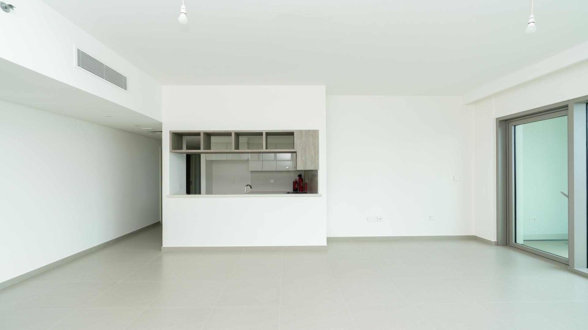 Empty living room with large windows and city views in Downtown Dubai apartment for rent