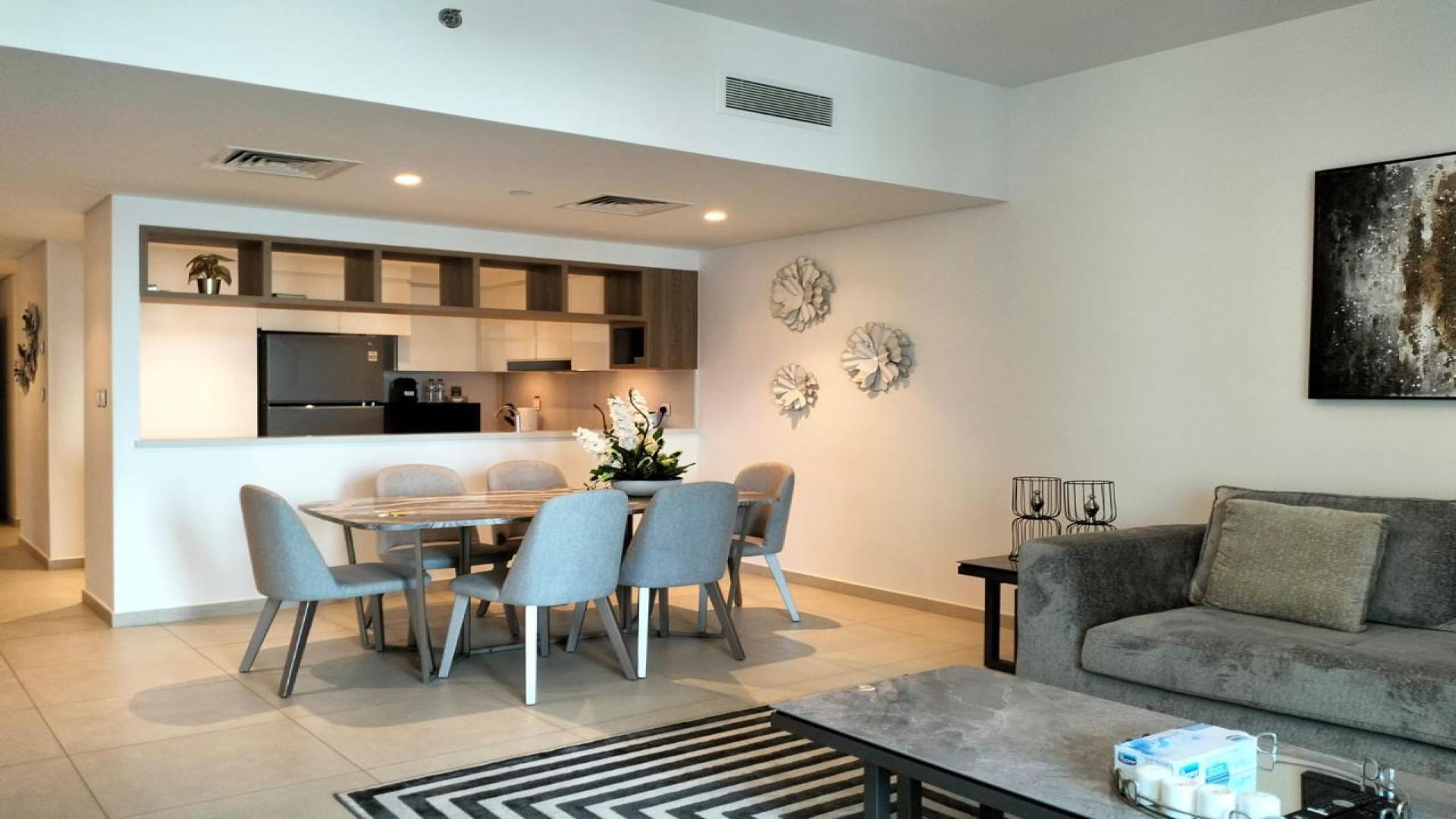 Furnished living room in Downtown Dubai apartment with modern decor and cozy seating arrangement