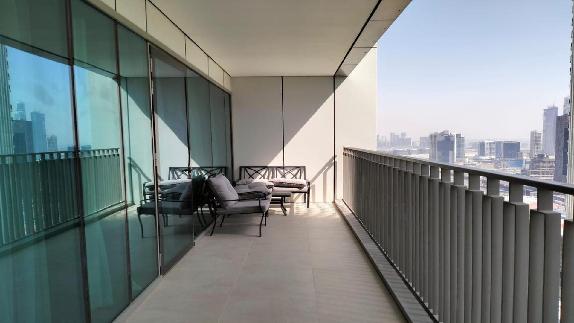 Furnished living room in Downtown Dubai apartment with modern decor and natural light