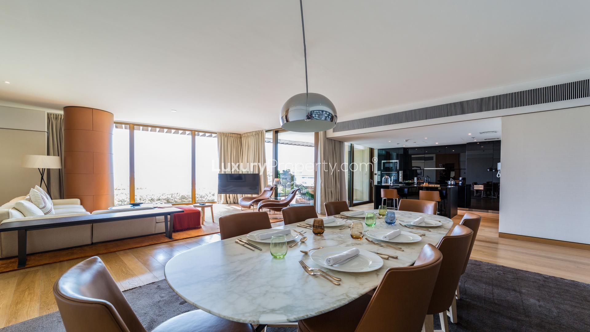 Luxurious Jumeirah Bay Island apartment living room with sea and marina views, modern furnishings