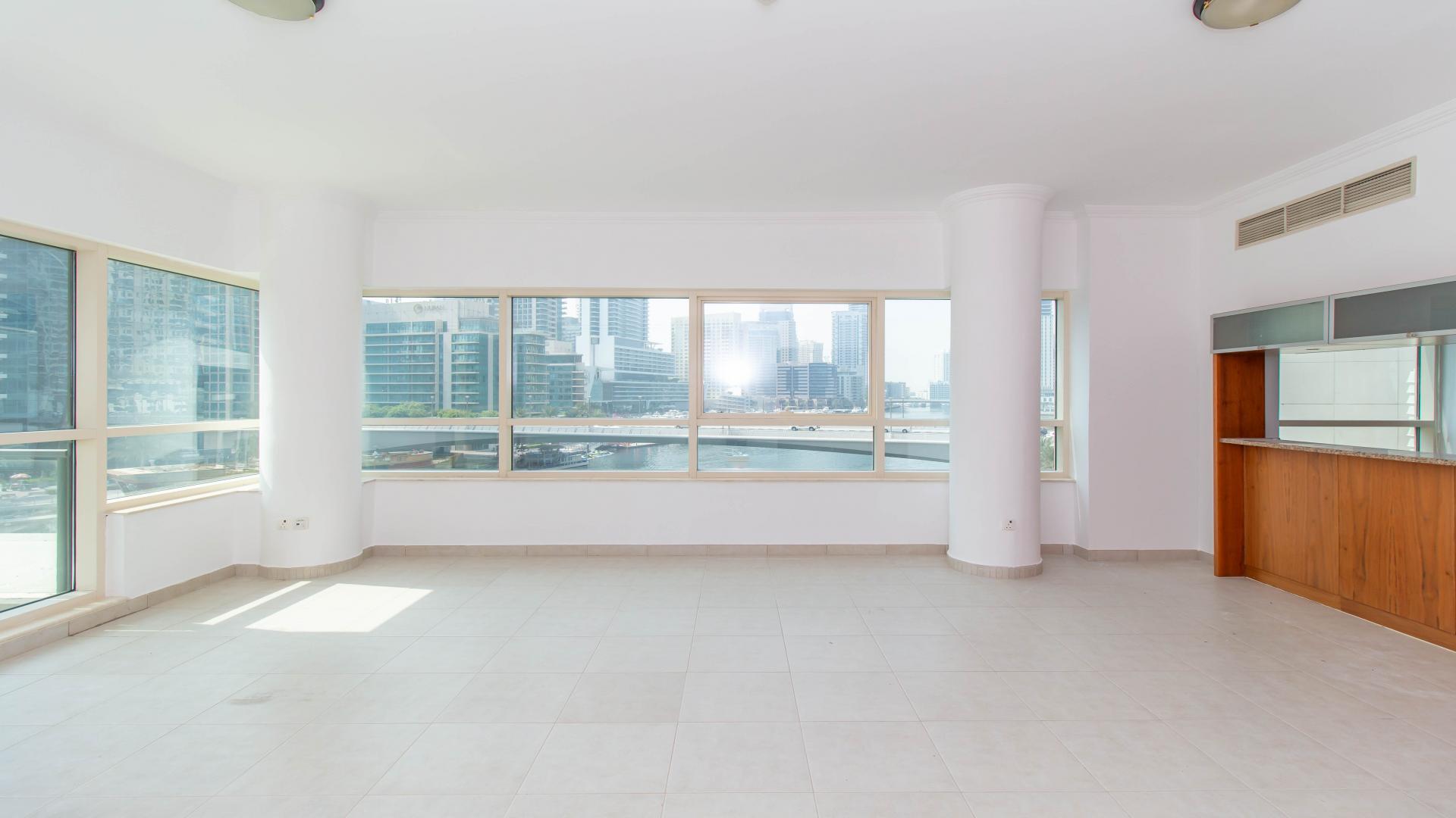 Spacious living area with large windows in Dubai Marina apartment, Marina Quay West