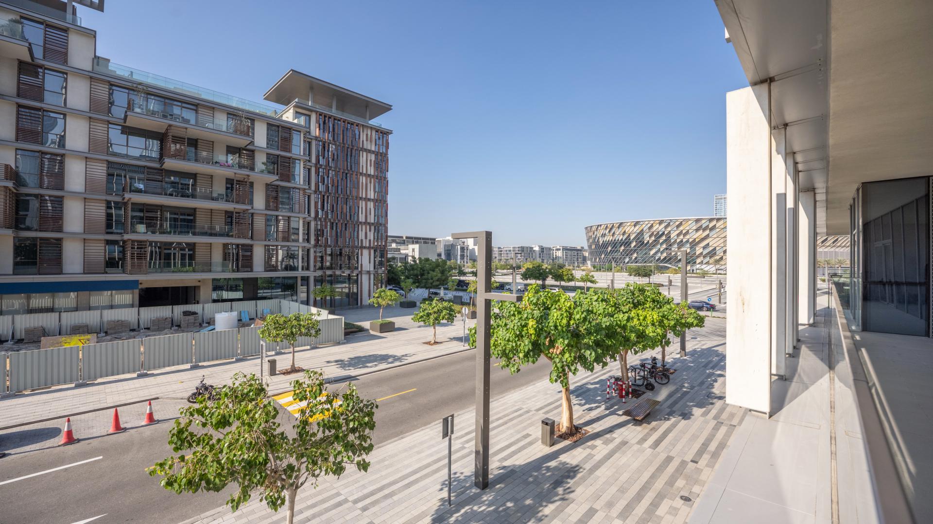 Open-plan living area in City Walk Dubai apartment with modern kitchen and large windows