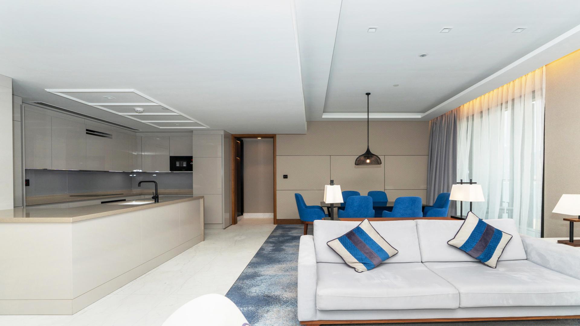 Modern living room in Bluewaters Residences apartment, featuring elegant decor and city views