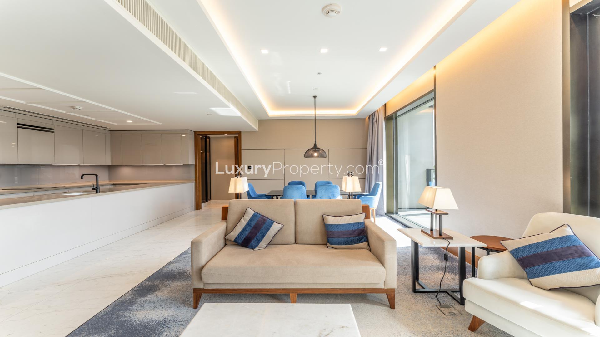 Luxurious open-plan living area in Bluewaters Residences apartment, featuring modern kitchen and seating