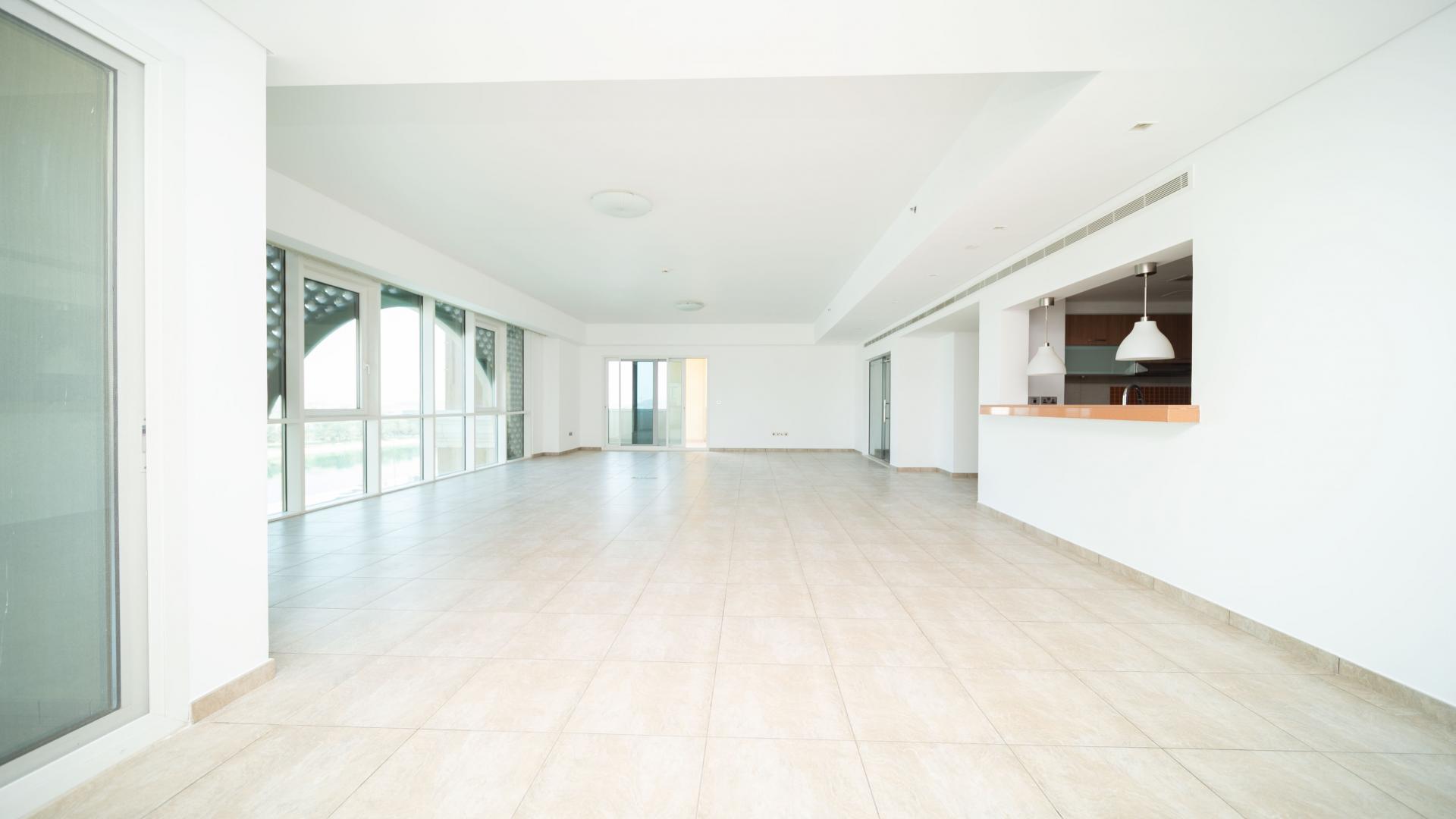 "View of marina from Palm Jumeirah apartment, showcasing yachts and waterfront skyline.",Vacant 3-bedroom apartment interior, spacious living area, Marina Residences, Palm Jumeirah