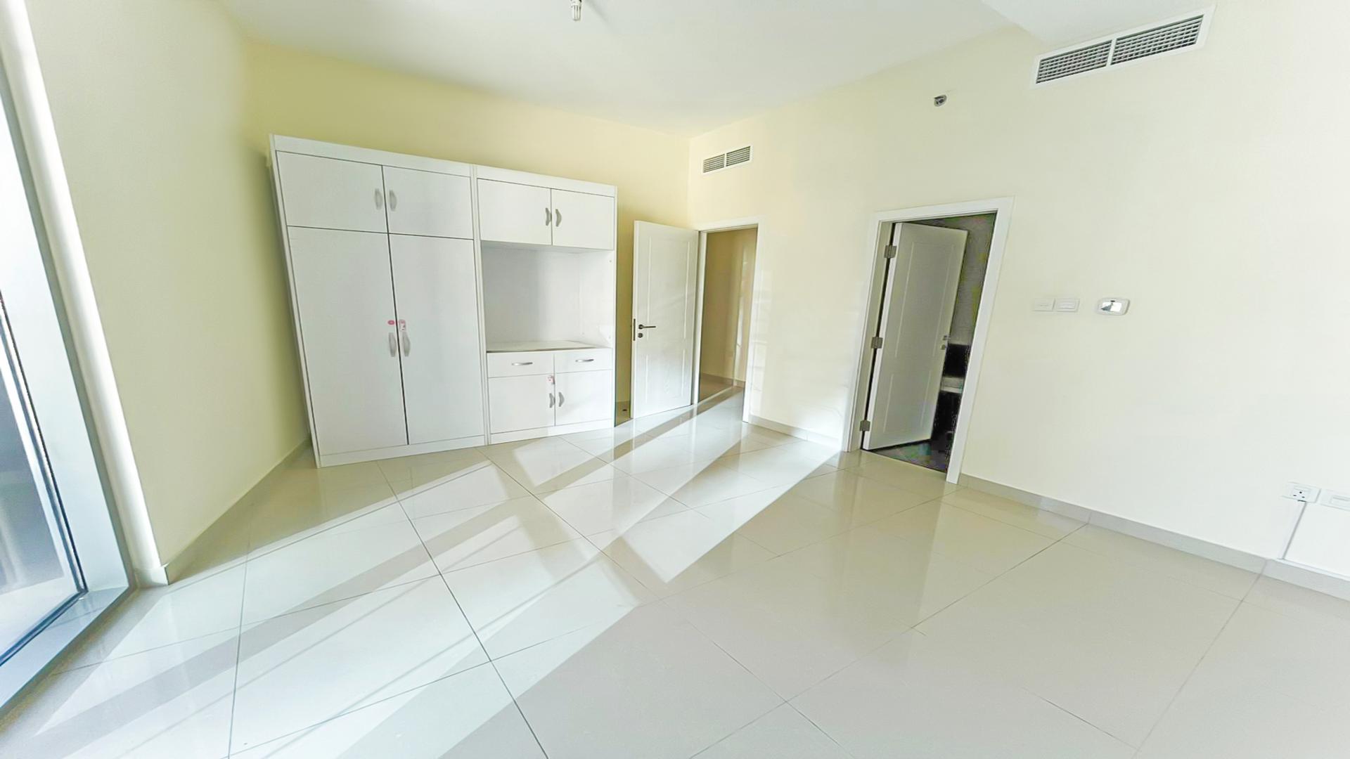 "Bright hallway in 3-bedroom Marina Wharf apartment, Dubai Marina, with white doors and tiles.",Empty bedroom with white wardrobe in Marina Wharf apartment, Dubai Marina