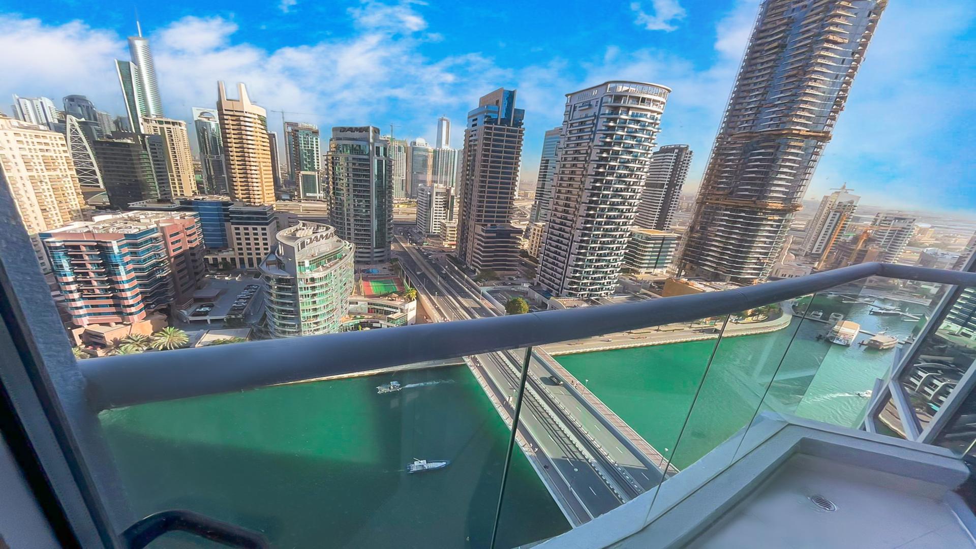 "Outdoor tennis court at Marina Wharf apartment complex, Dubai Marina, surrounded by skyscrapers.",N/A,Fitness center with modern equipment in Marina Wharf, Dubai Marina apartment for rent