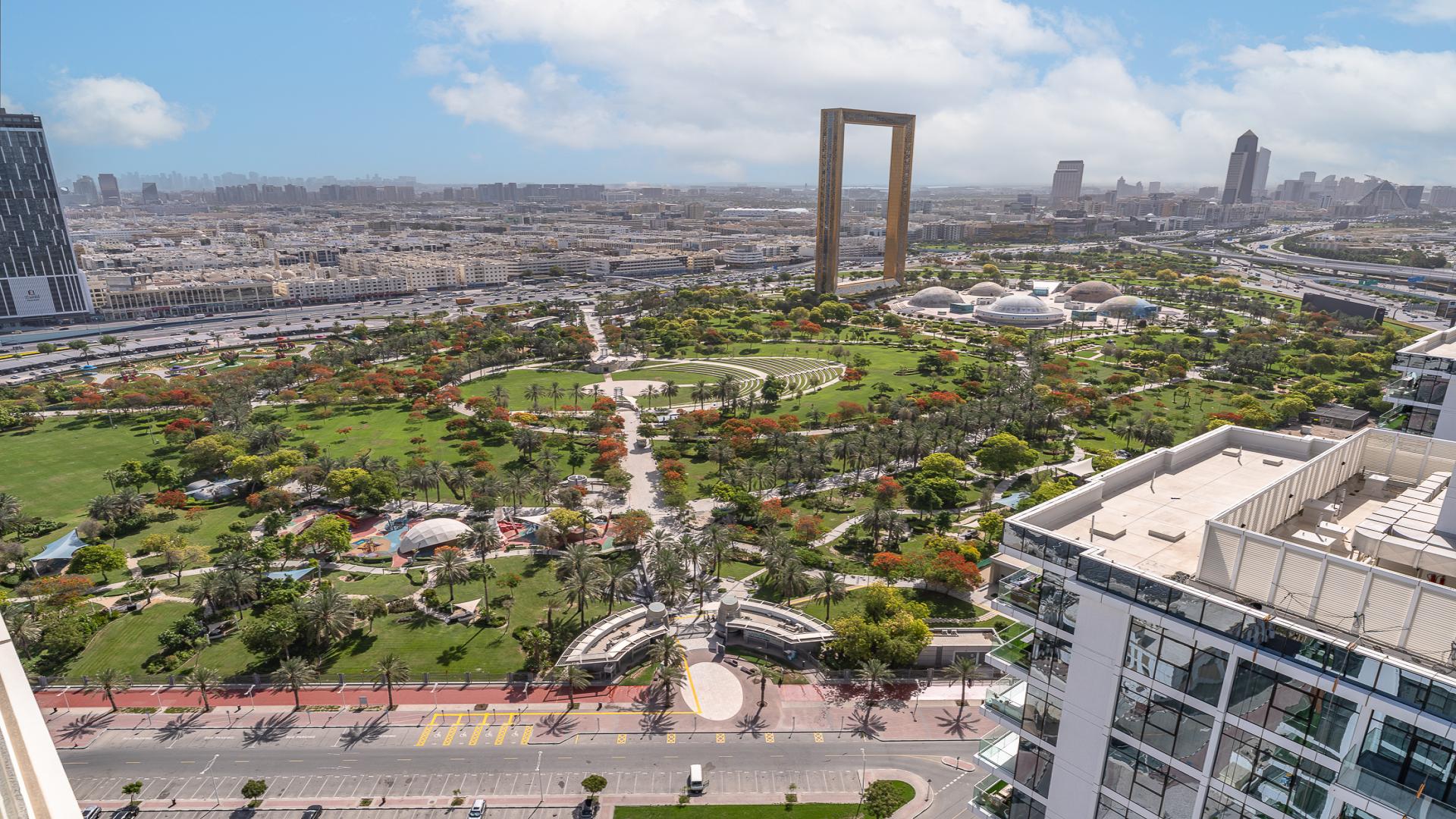 High-floor apartment balcony with partial park view in Al Wasl Gate, Park Gate
