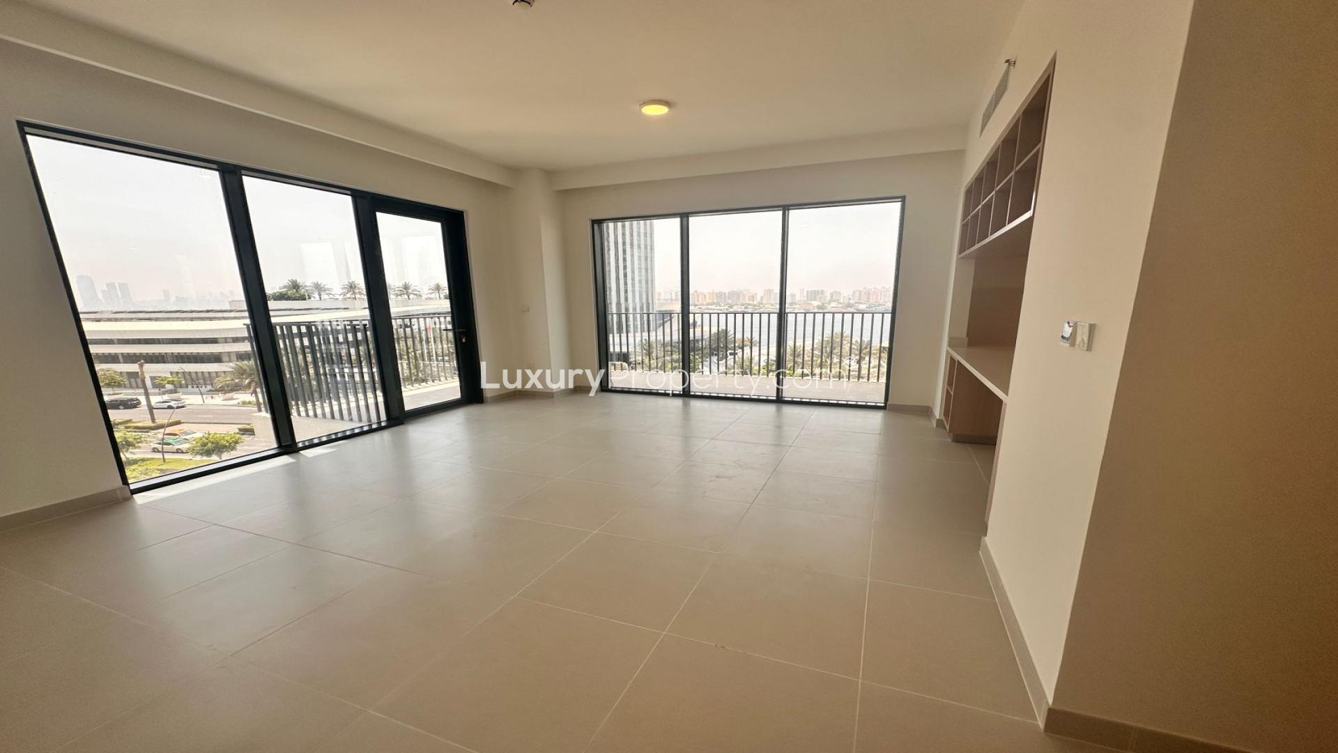 Modern living room in Dubai Creek Harbour apartment, spacious layout with large windows