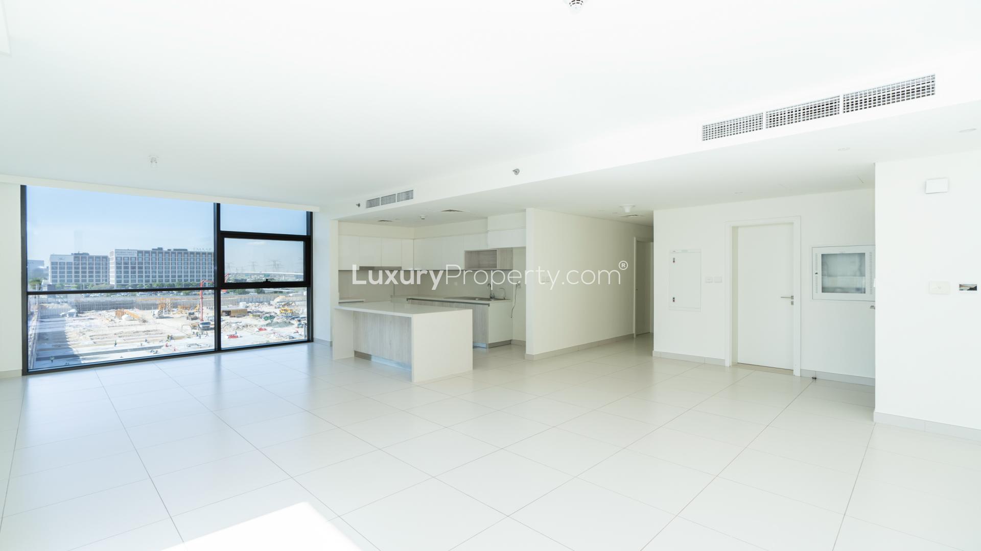 "Balcony view of Park Point apartment complex in Dubai Hills Estate, modern architecture.",Spacious living area with large windows in Park Point apartment, Dubai Hills Estate