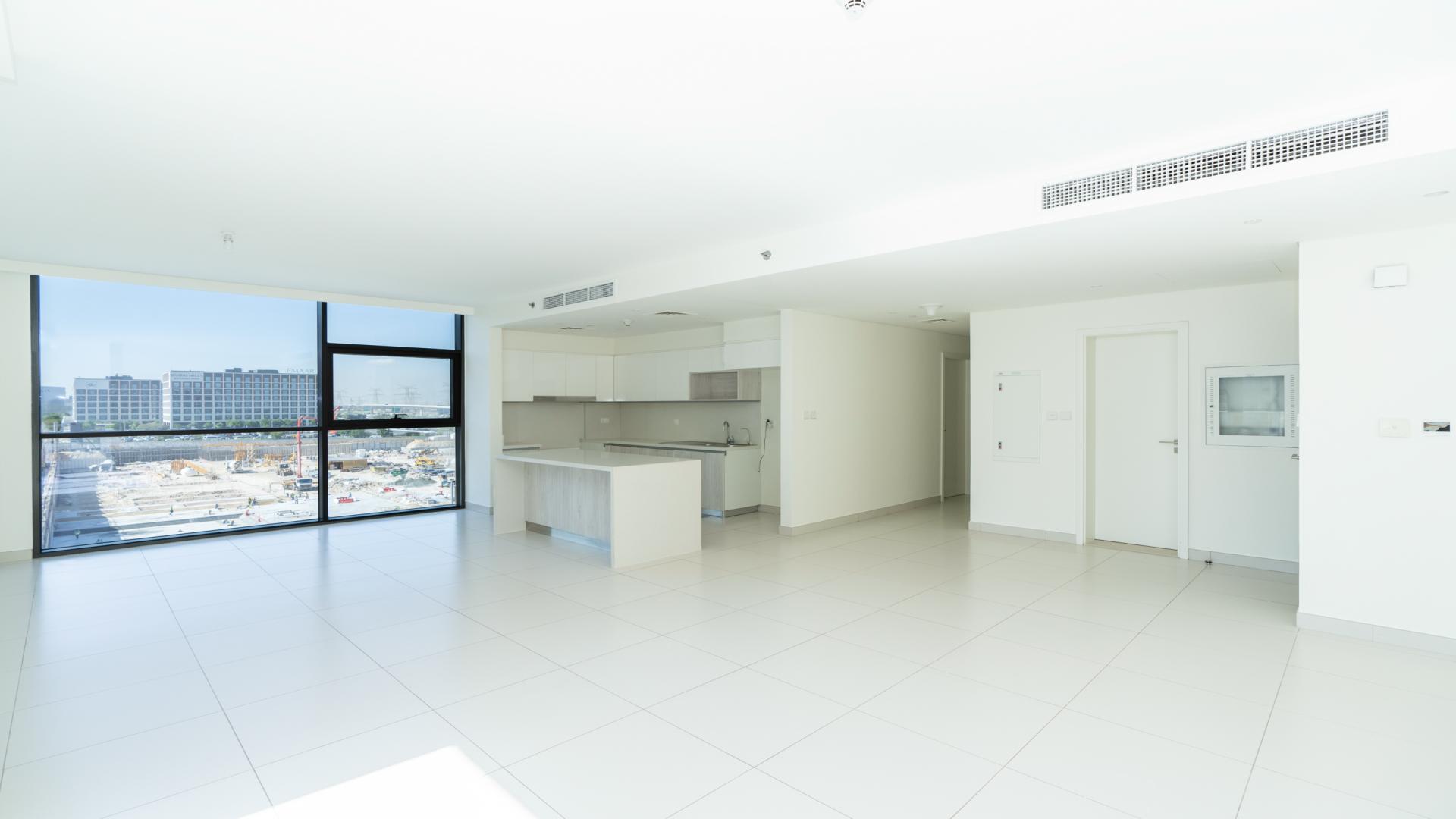 "Balcony view of Park Point apartment complex in Dubai Hills Estate, modern architecture.",Spacious living area with large windows in Park Point apartment, Dubai Hills Estate