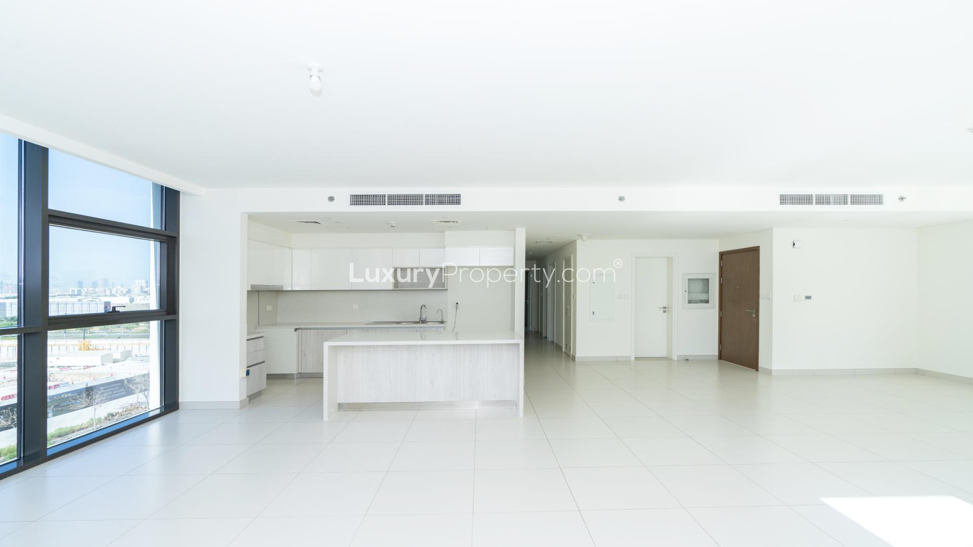 Modern open-plan kitchen and living area in 3-bedroom Dubai Hills apartment for rent