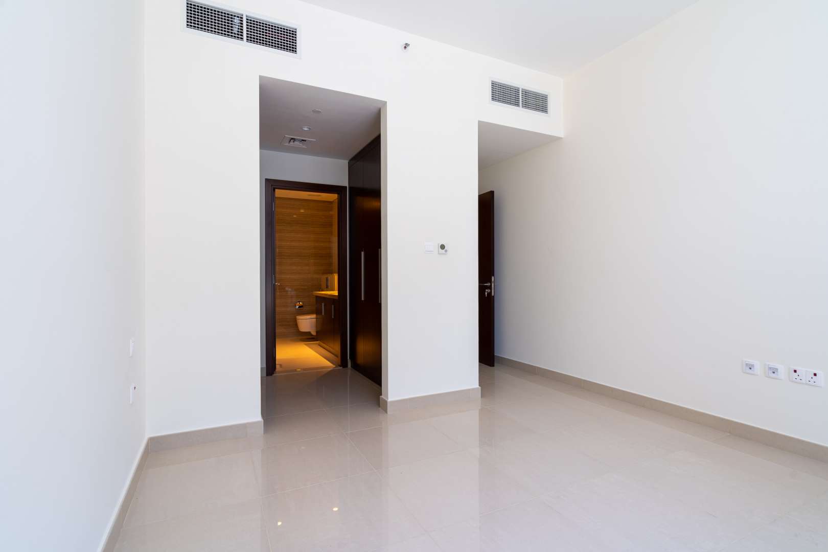 Bright bedroom with en-suite bathroom in Dubai Hills Estate apartment for rent