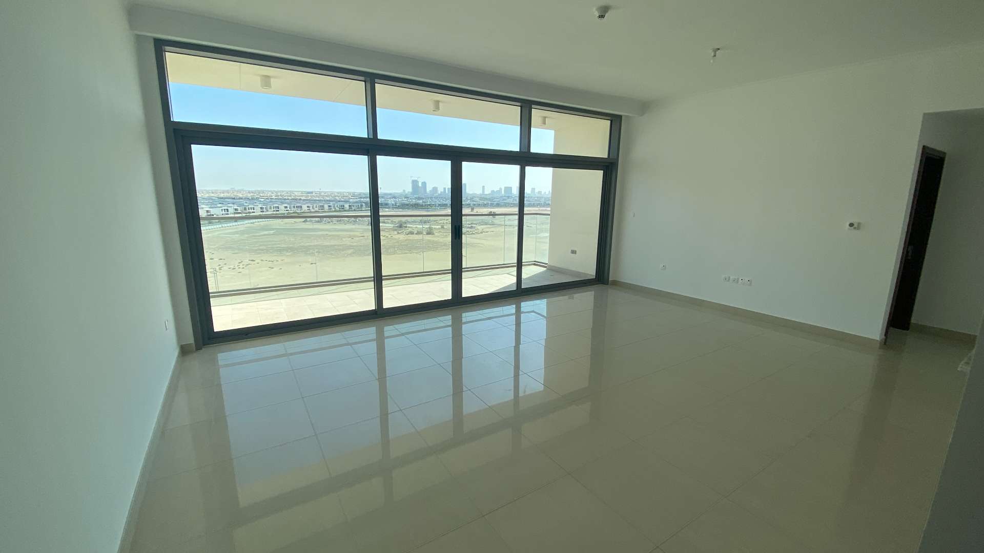 Empty bedroom with large window in Mulberry Park Heights, Dubai Hills Estate apartment