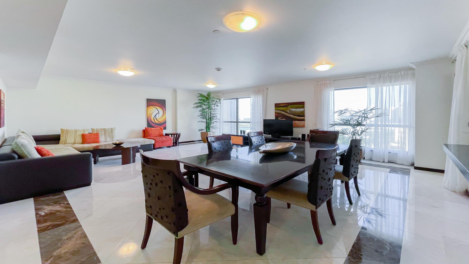 "Jumeirah Beach Residence skyline view from Murjan apartment, featuring tennis courts and skyscrapers.",Contemporary living room in Jumeirah Beach Residence apartment, elegant decor, bright natural light