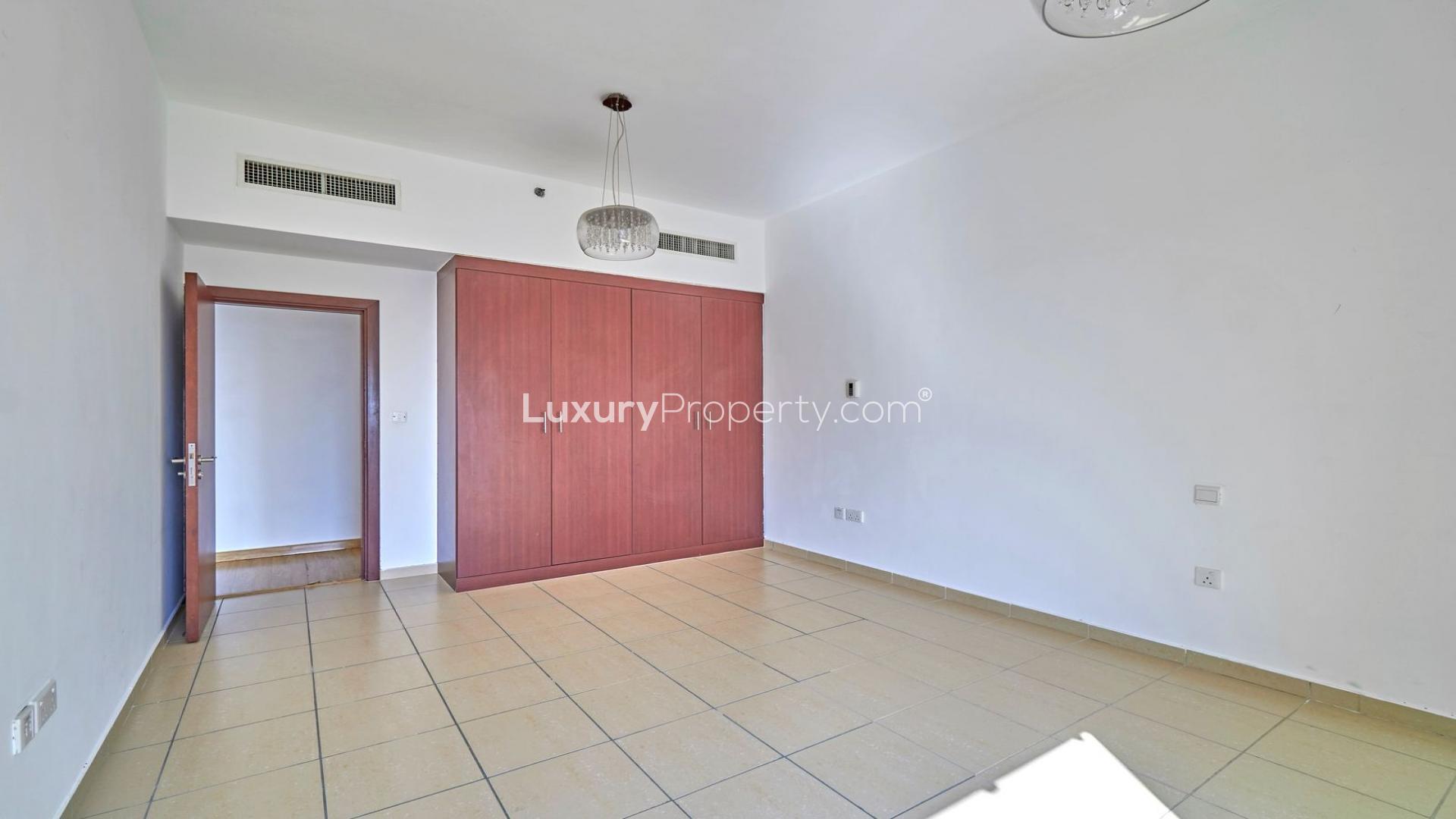 Empty bedroom with wooden closet in Jumeirah Beach Residence apartment, Rimal sub-community