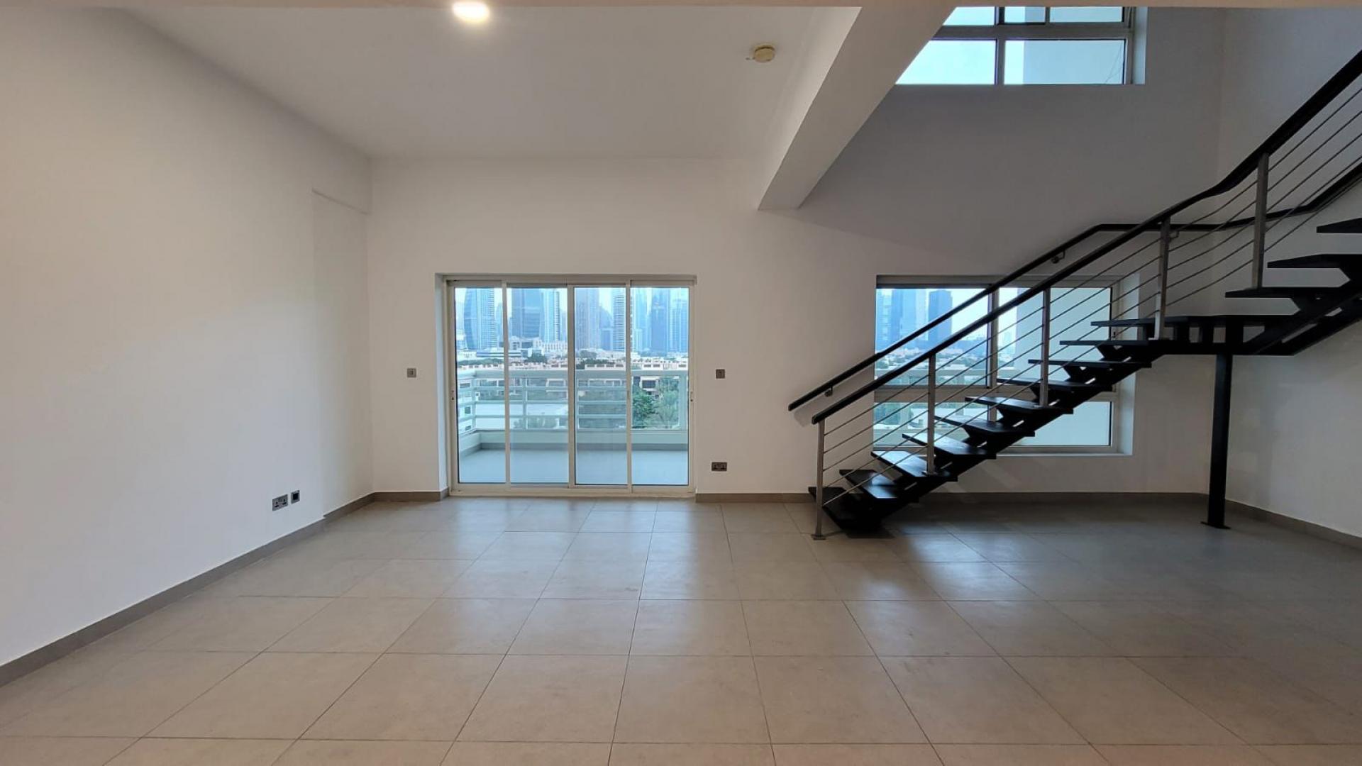 Modern kitchen in 3-bed duplex, Jumeirah Heights Cluster E, with granite countertops and appliances