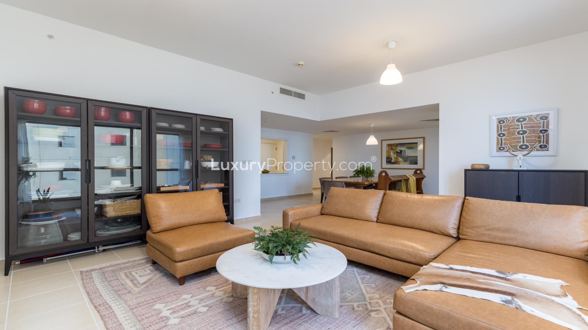 Gorgeous JBR apartment living room with modern furnishings, large windows, and cozy layout