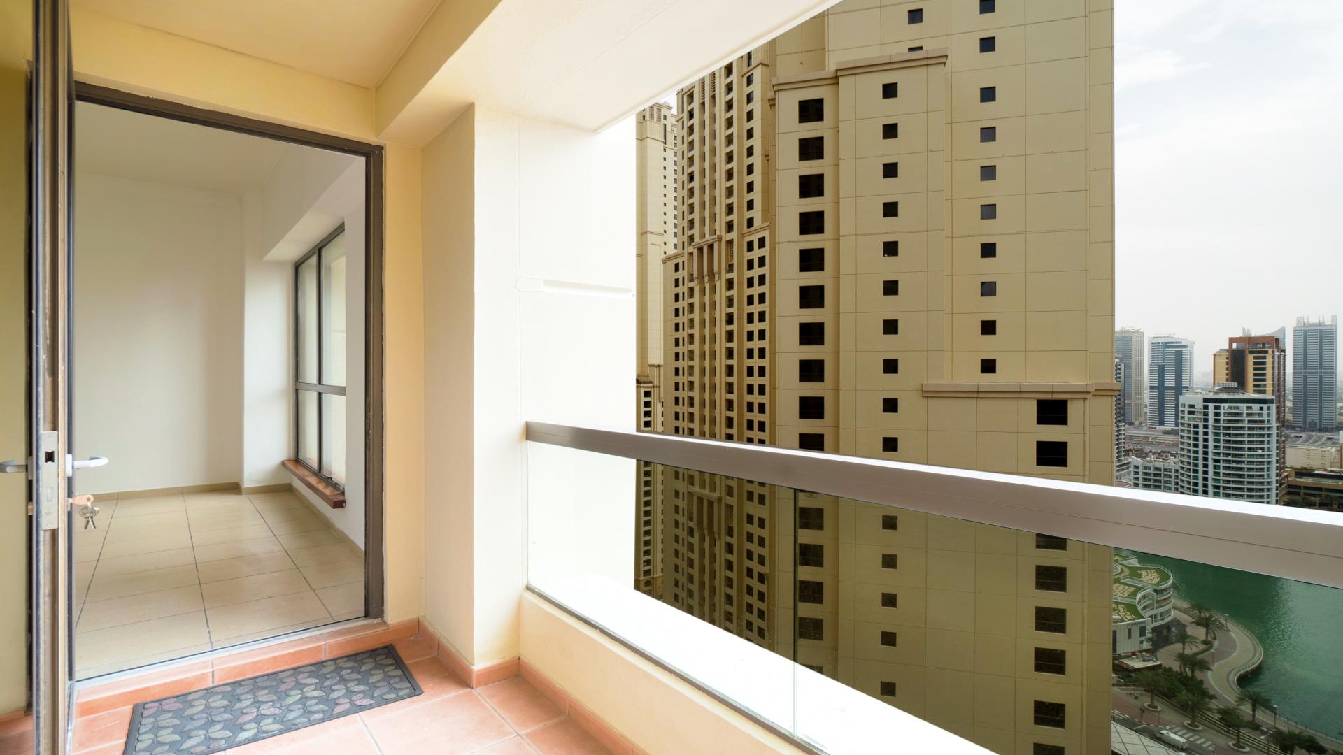 Empty living room with large windows and marina view in Sadaf, JBR apartment, Dubai