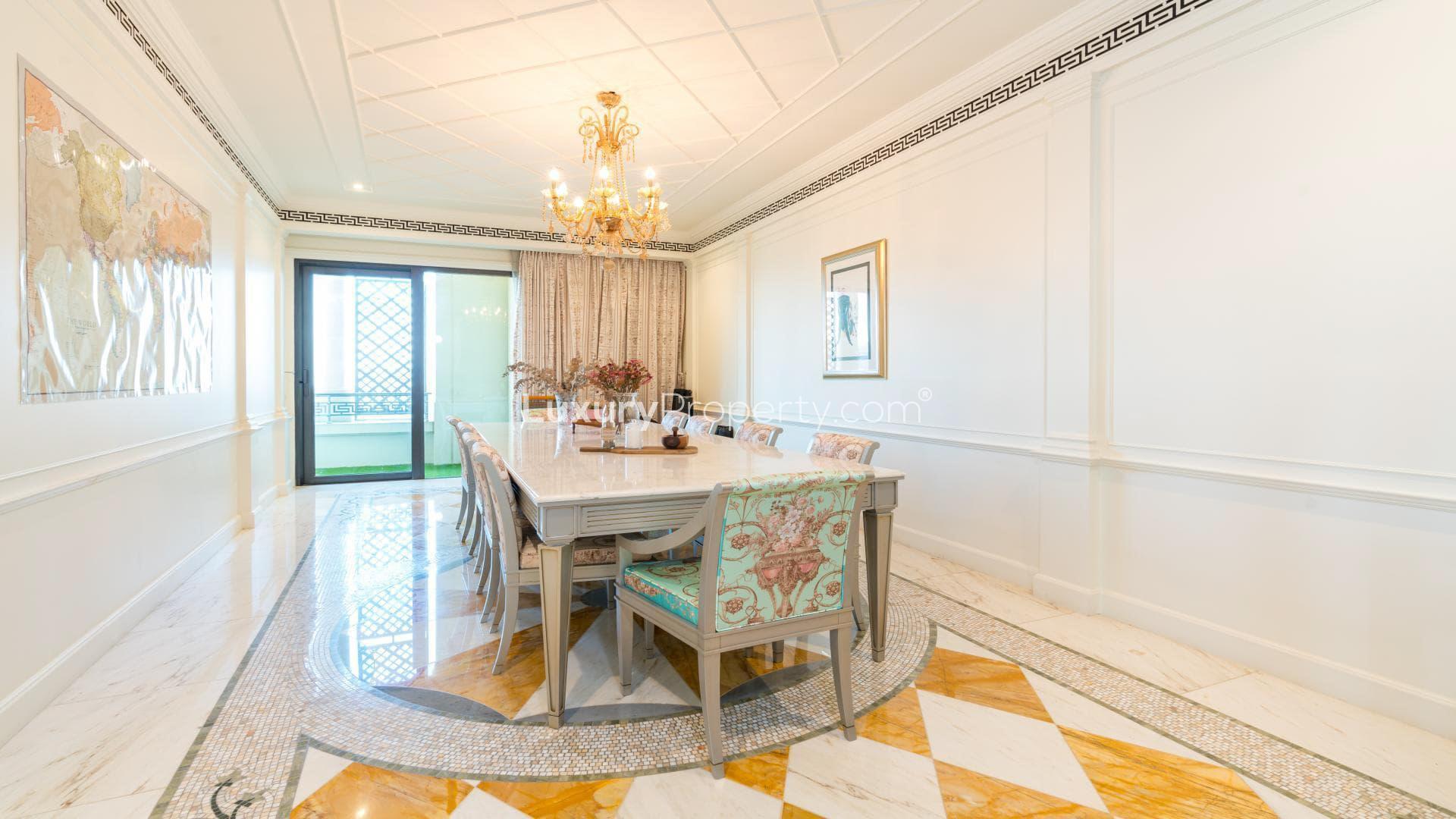Luxurious dining area in Palazzo Versace apartment, Culture Village, featuring elegant chandelier and decor
