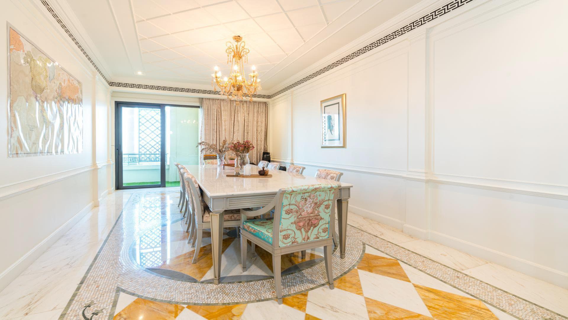 Luxurious dining area in Palazzo Versace apartment, Culture Village, featuring elegant chandelier and decor
