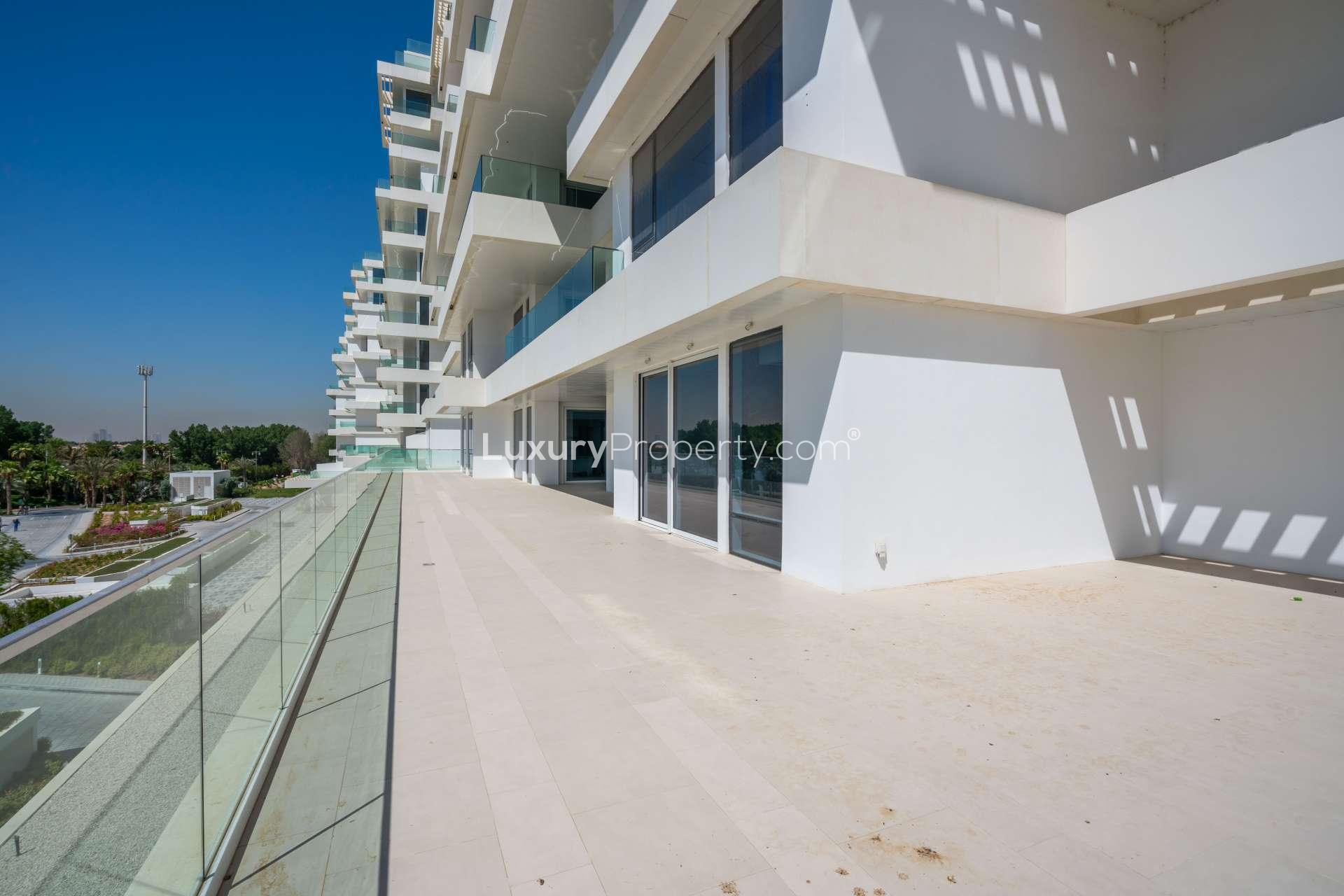 Spacious terrace of luxury apartment in Seventh Heaven, Al Barari, with glass balustrades
