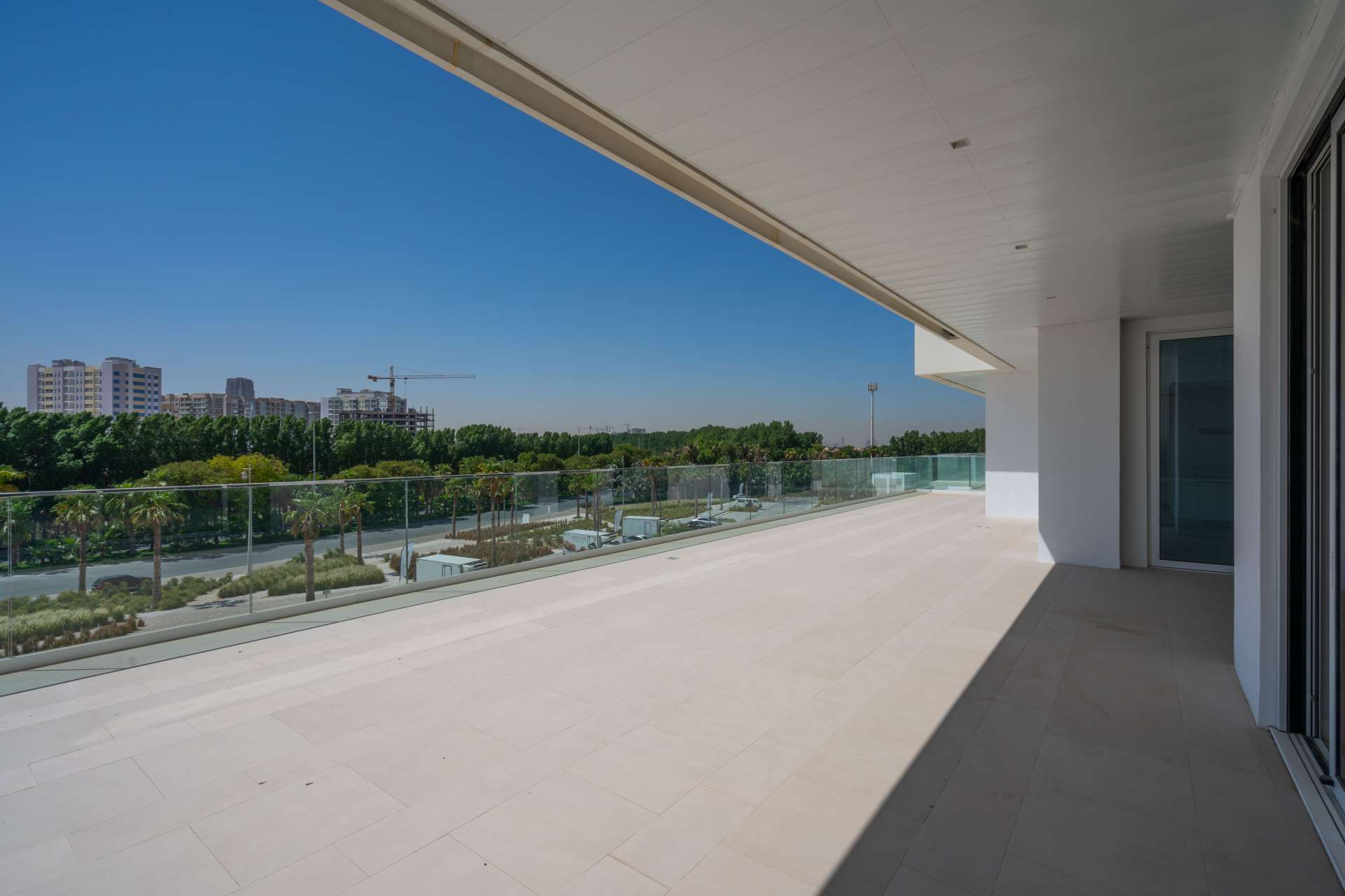 "Spacious living area in 3-bedroom apartment, Seventh Heaven, Al Barari, with large windows.",Spacious terrace view from 3-bedroom apartment in Seventh Heaven, Al Barari for rent