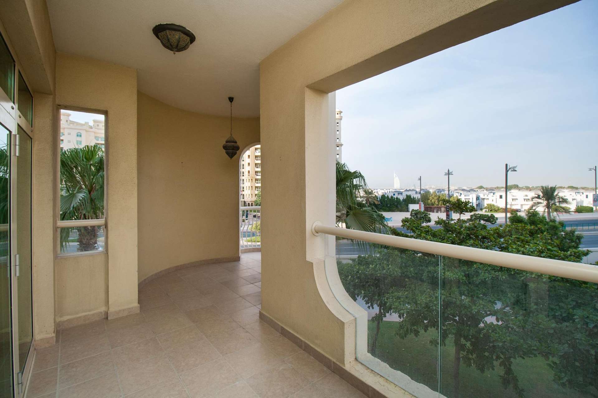 View from Shoreline Residences apartment, Palm Jumeirah, showcasing nearby buildings and lush greenery
