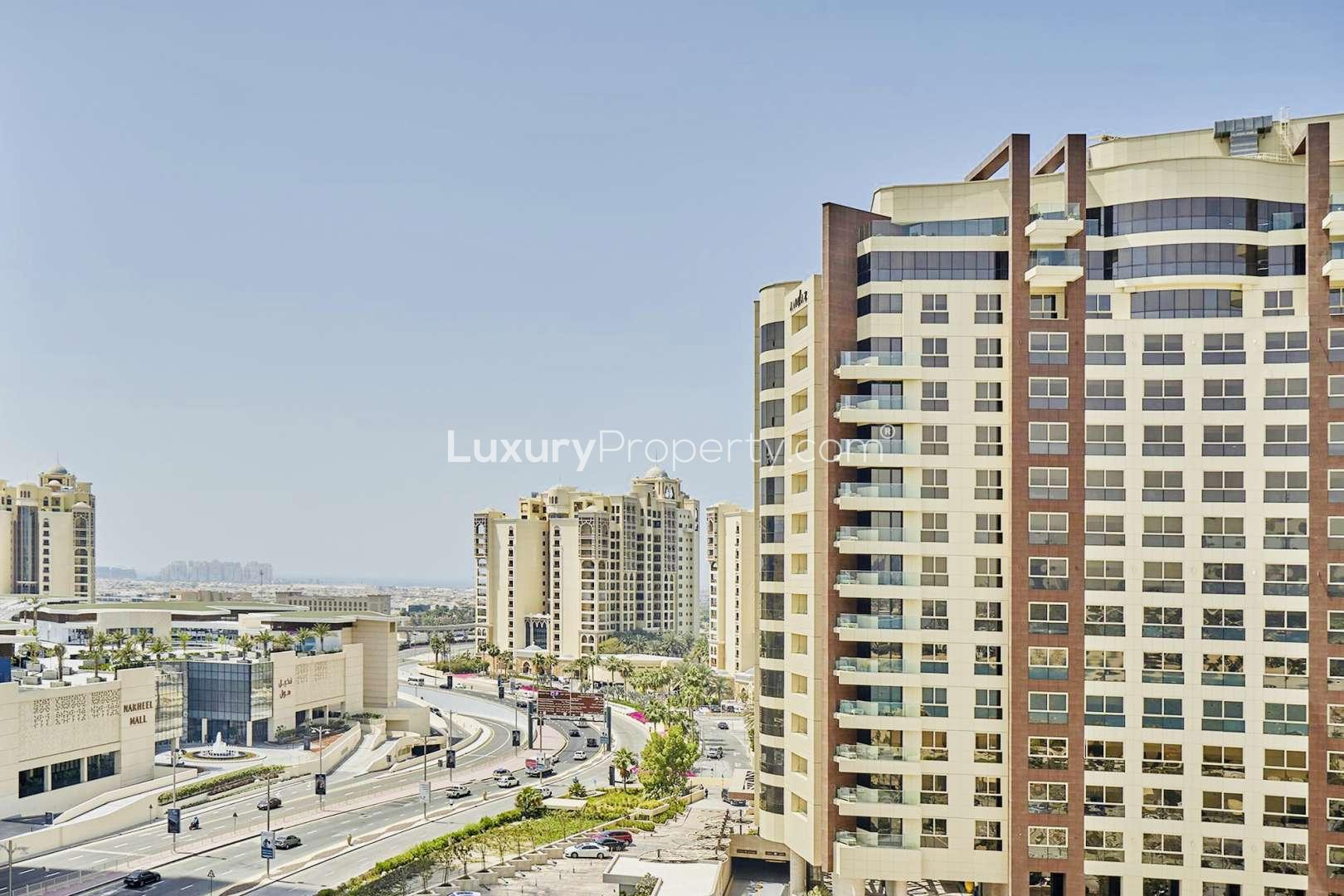 "Spacious bedroom in 3-bed Shoreline apartment, Palm Jumeirah. Modern decor with natural light.",Shoreline Apartments exterior, Palm Jumeirah view, near Nakheel Mall, perfect family rental