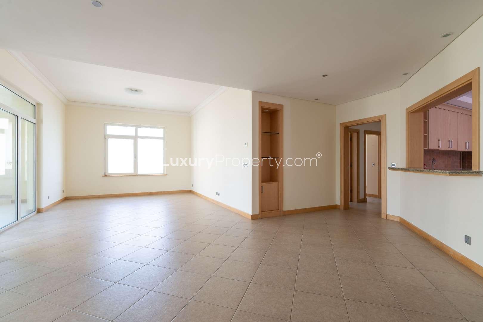 Empty room with sea view window in Shoreline Palm Jumeirah apartment for rent
