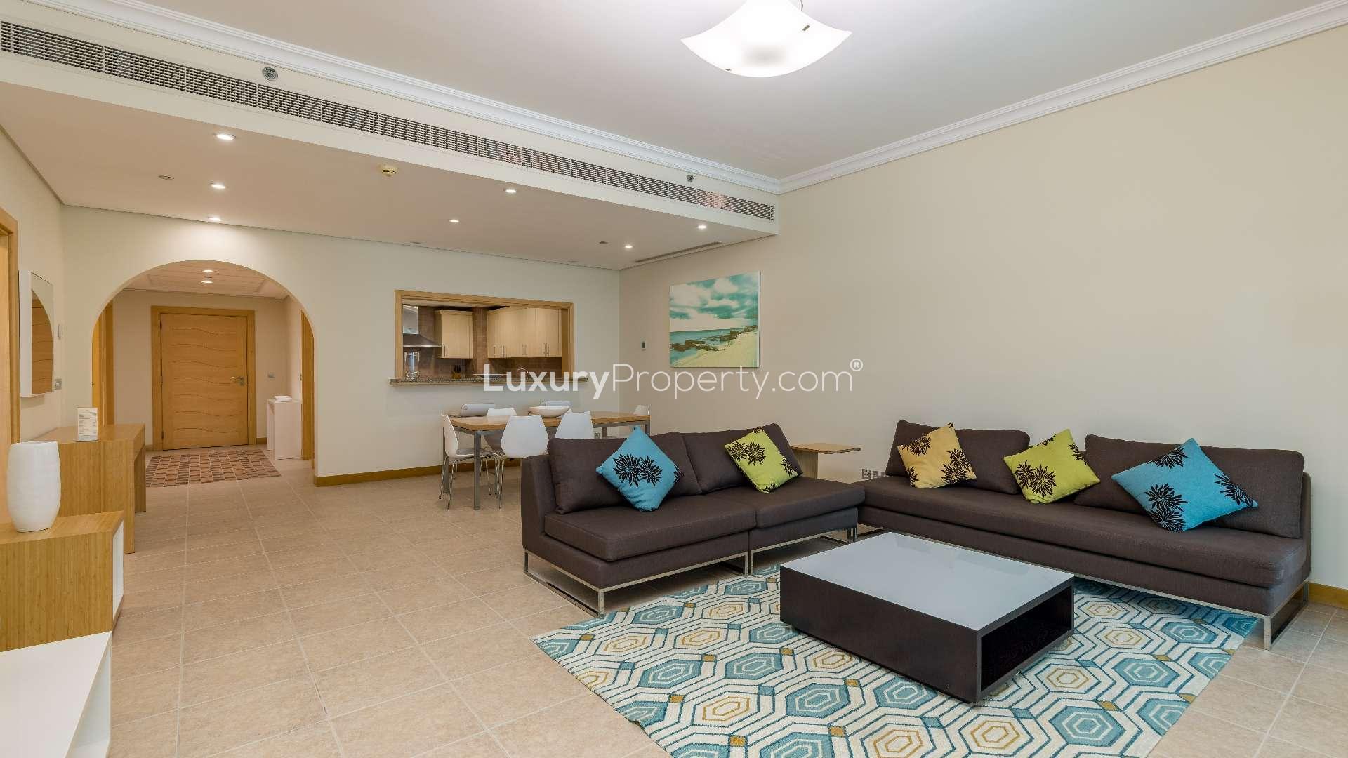 Furnished living room in Shoreline Apartments, Palm Jumeirah with modern decor and open kitchen