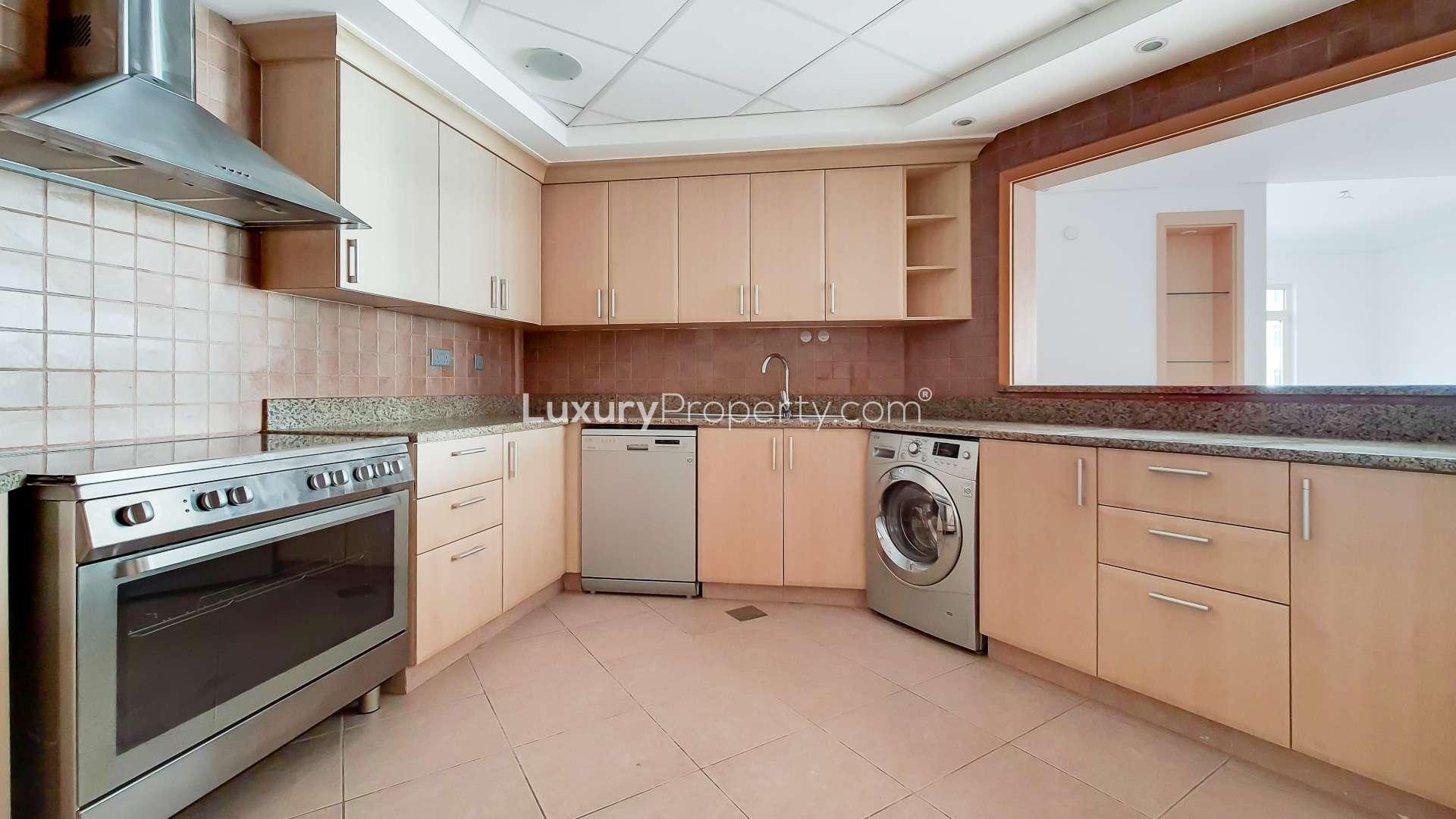 Empty modern living room with large windows in Palm Jumeirah apartment, Shoreline Apartments