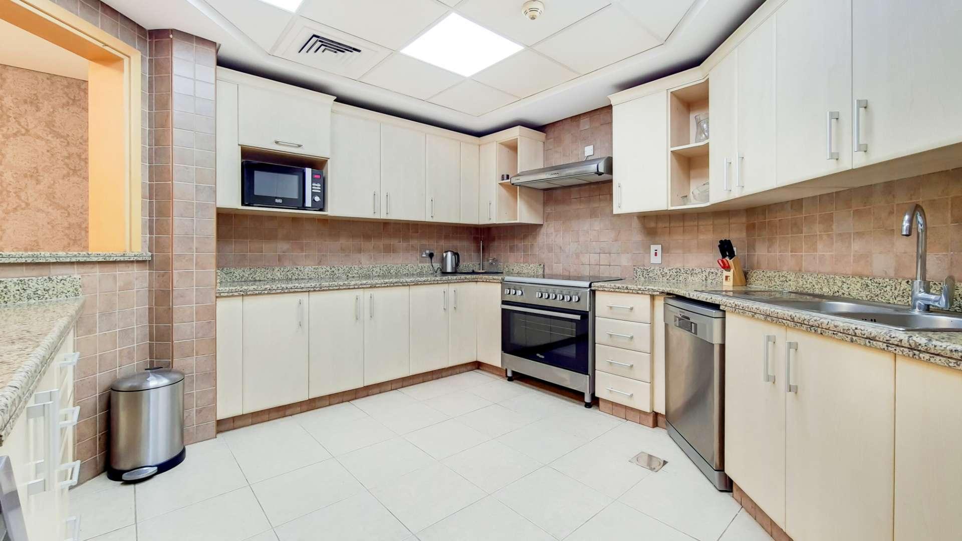 Luxurious furnished living room in Shoreline, Palm Jumeirah apartment with balcony view