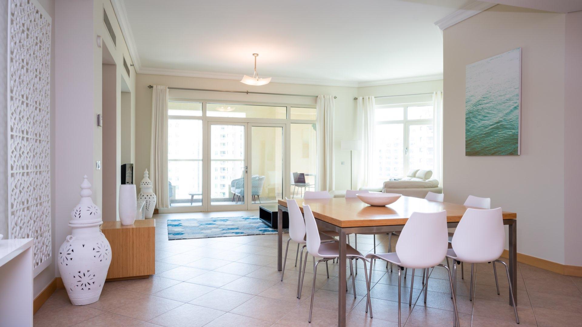 Furnished living room in Shoreline Apartments, Palm Jumeirah, with balcony view and modern decor