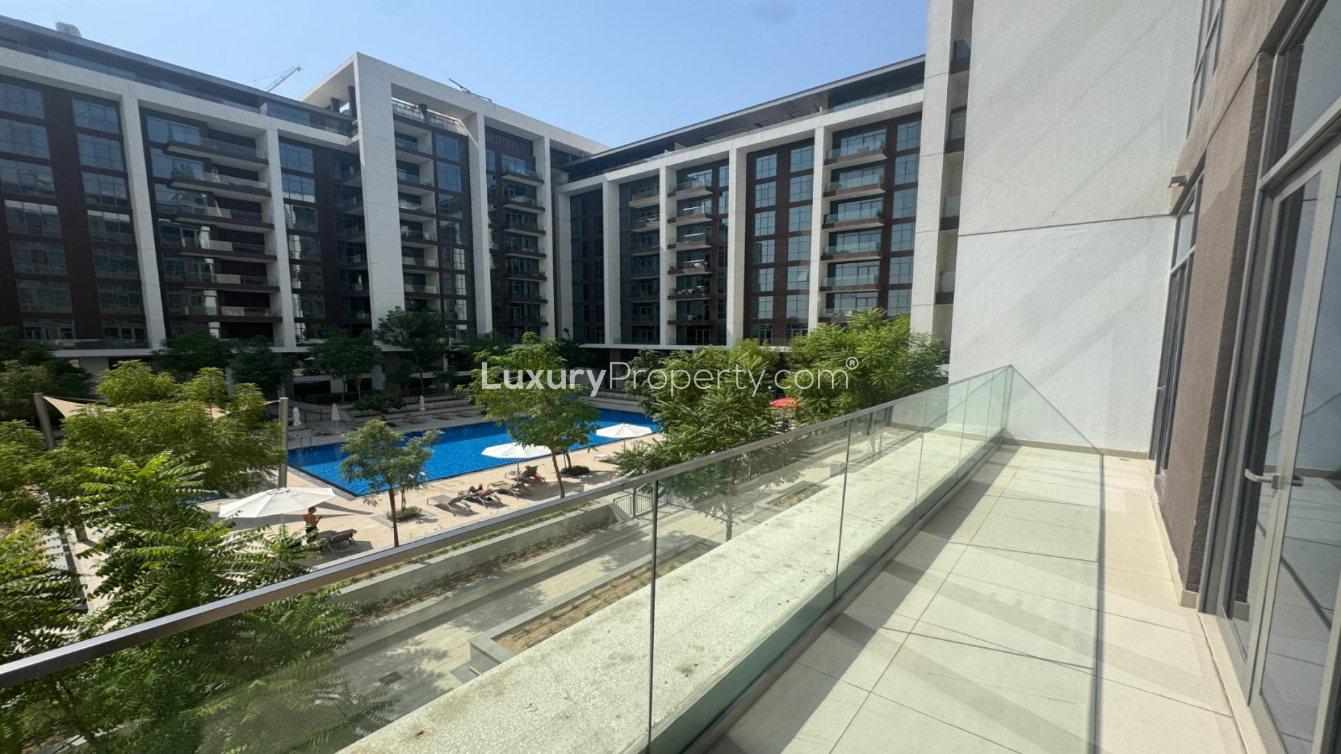Balcony view of Acacia Park Heights apartment in Dubai Hill Estate, overlooking lush greenery