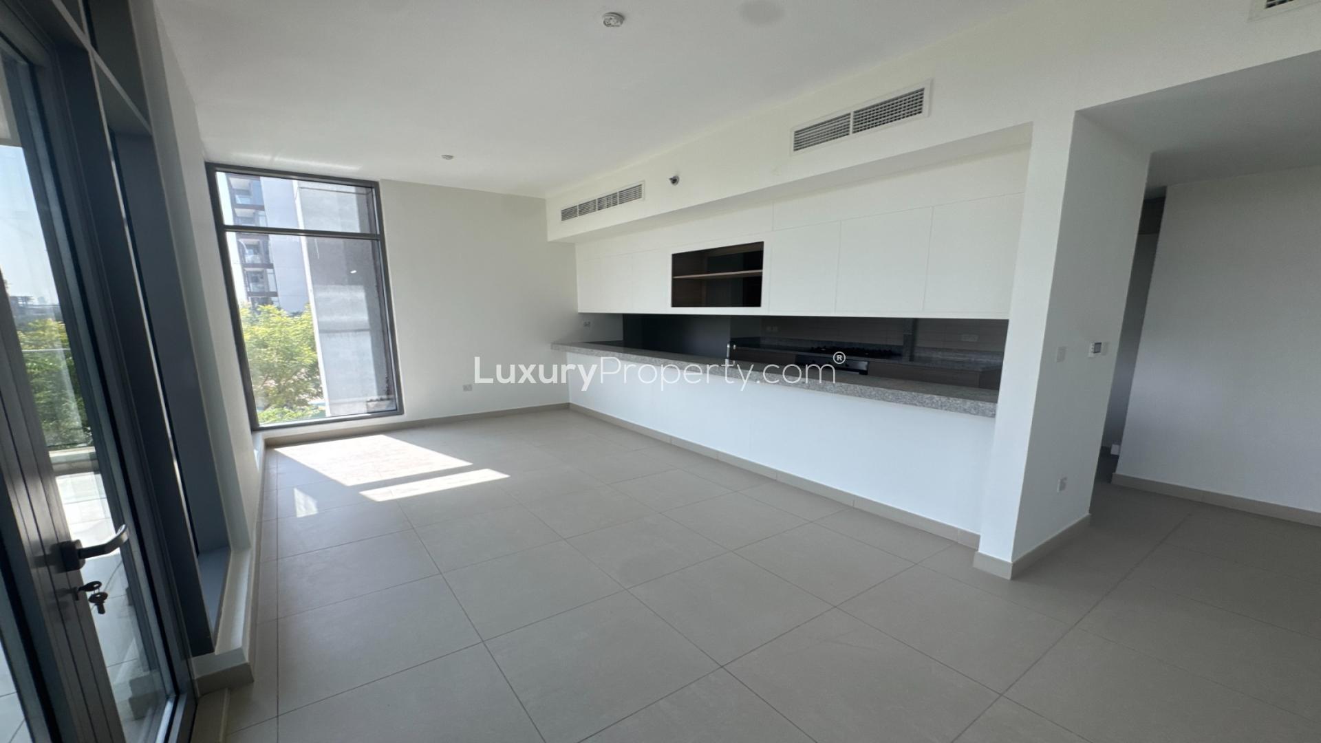 Balcony view of Acacia Park Heights apartment overlooking pool in Dubai Hill Estate