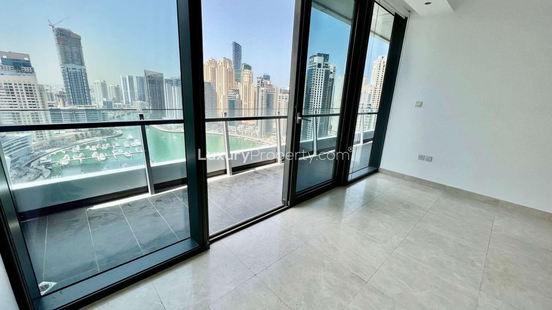 Balcony view from Silverene Tower apartment overlooking Dubai Marina skyscrapers and waterfront