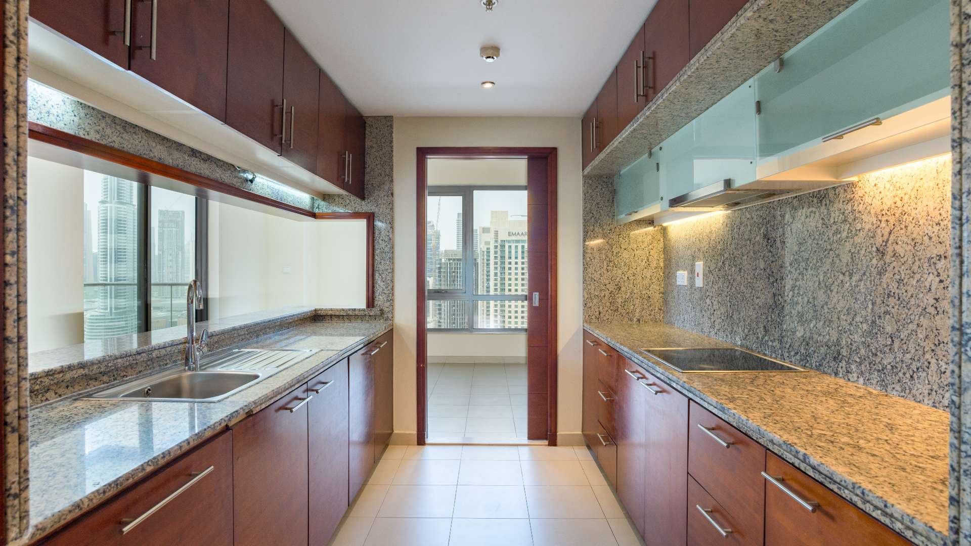 Unfurnished kitchen and living area with Burj Khalifa view in Downtown Dubai apartment