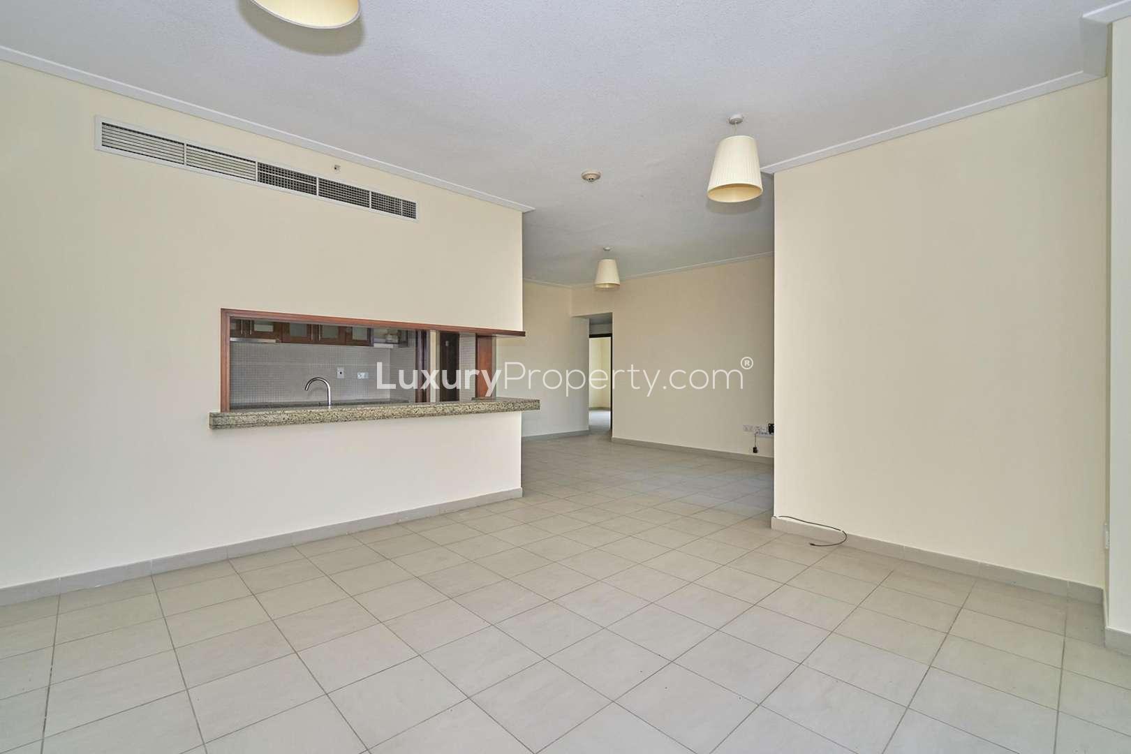 Empty bedroom with large window and built-in wardrobe in Downtown Dubai apartment