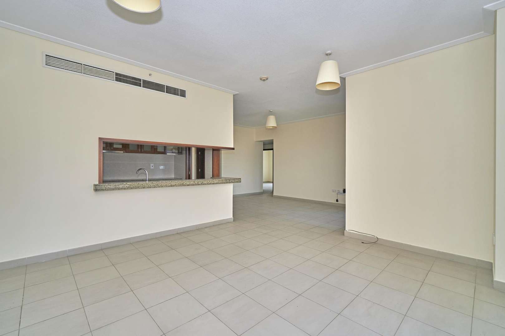 Empty bedroom with large window and built-in wardrobe in Downtown Dubai apartment