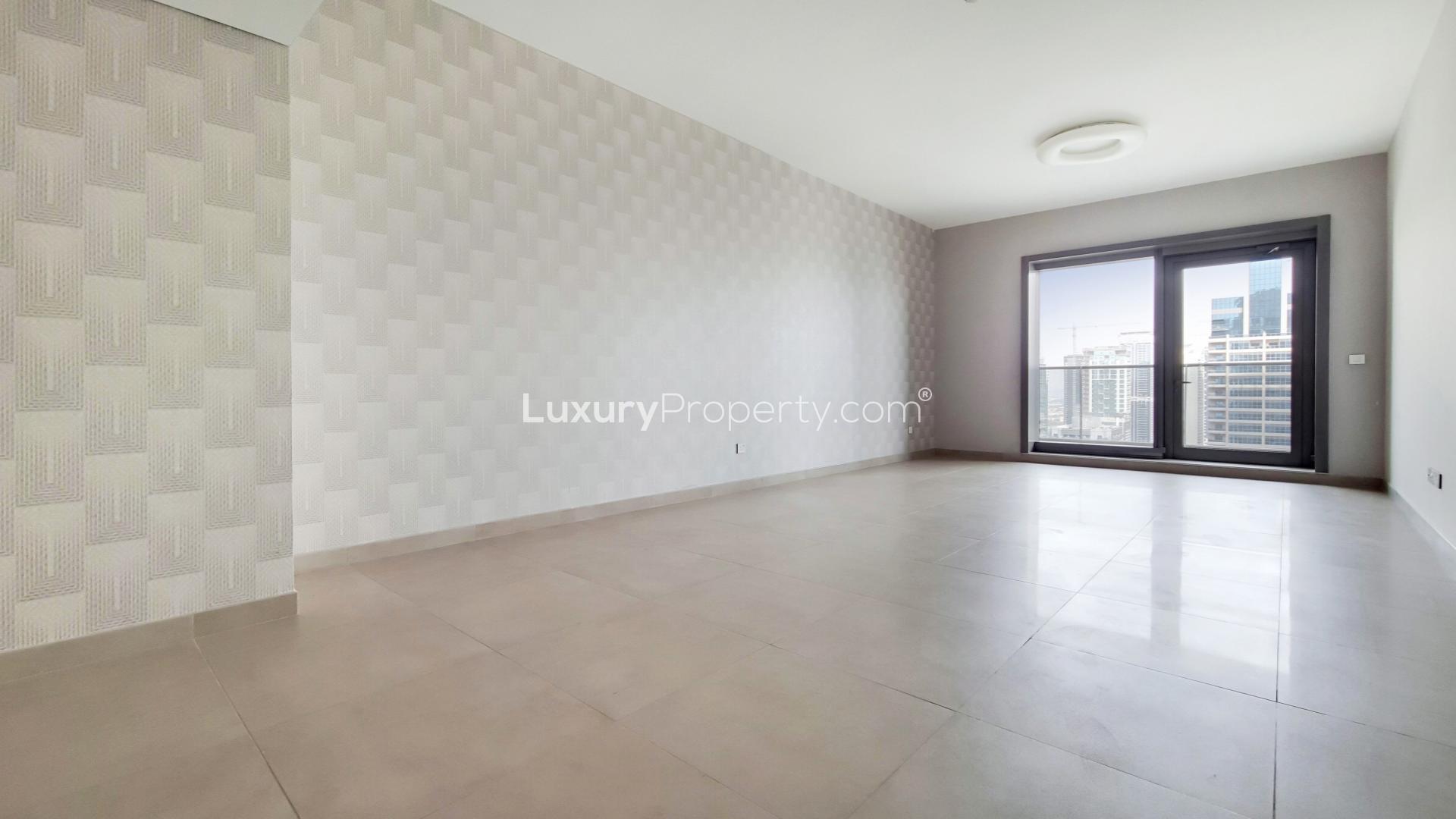 "Spacious living room with modern design, large windows, Dubai Marina view in Sparkle Towers.","Bright apartment room with Dubai Marina skyline view, Sparkle Towers, for rent.",Empty apartment room with large windows and city views in Sparkle Towers, Dubai Marina