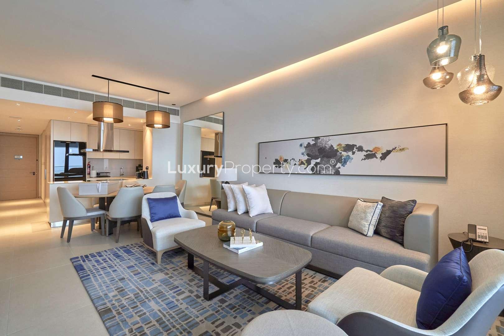 Modern living room in 3-bed villa, Juniper, Damac Hills 2, with stylish decor and balcony