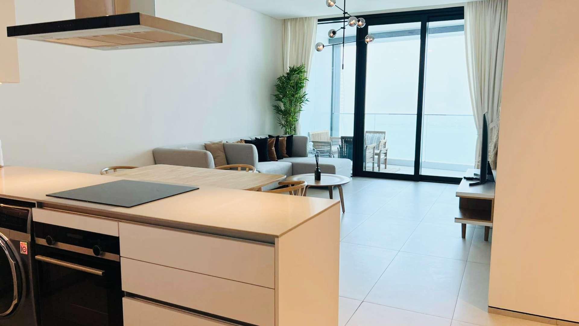 Furnished living room in beachfront apartment, Jumeirah Beach Residence, with balcony view