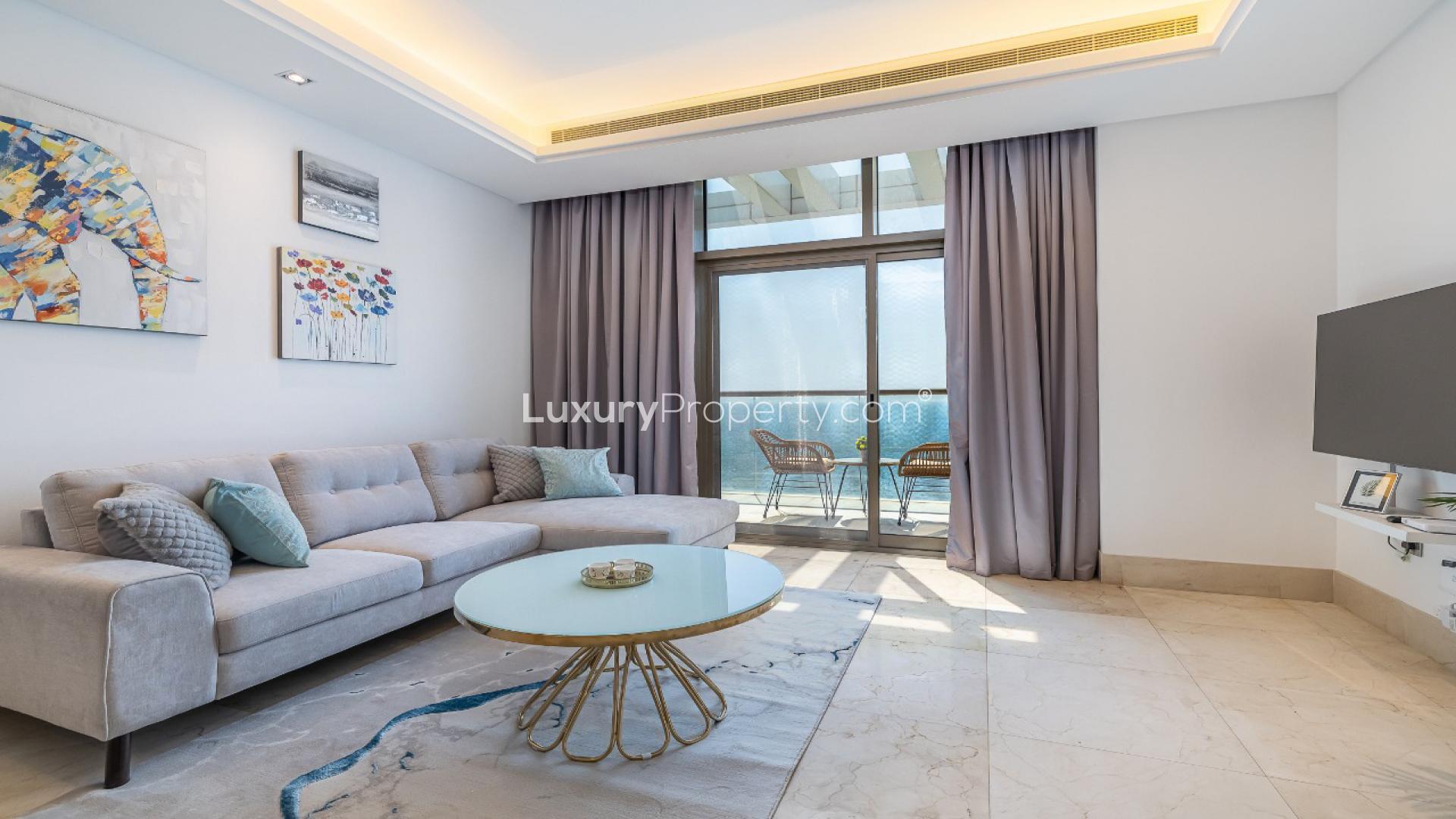 Modern living area in Palm Jumeirah apartment with elegant decor and open kitchen layout