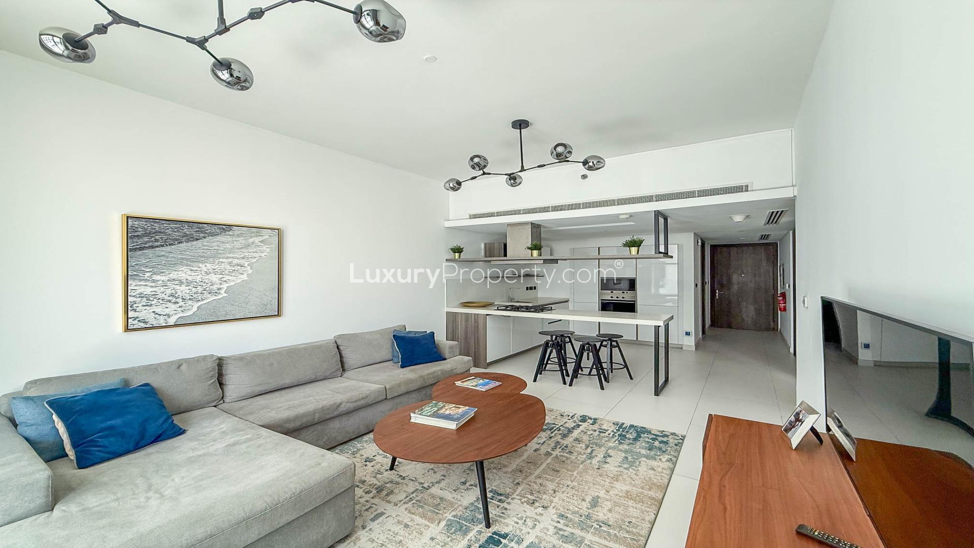 Modern furnished living room in Soho Palm Jumeirah apartment for rent with open kitchen